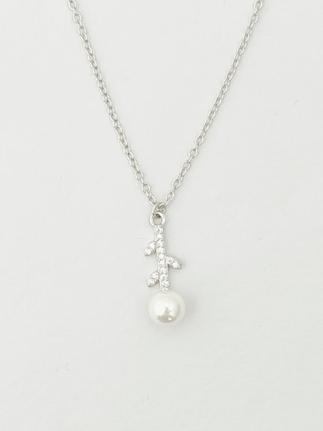 Pearl necklace with silver chain on a white background