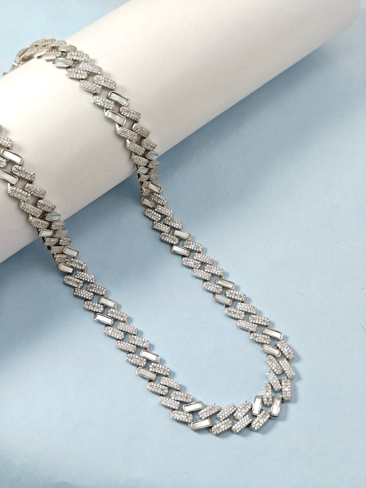 Silver chain necklace on a light blue background