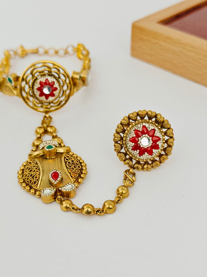 Gold jewelry set with earrings and bracelet on a light background