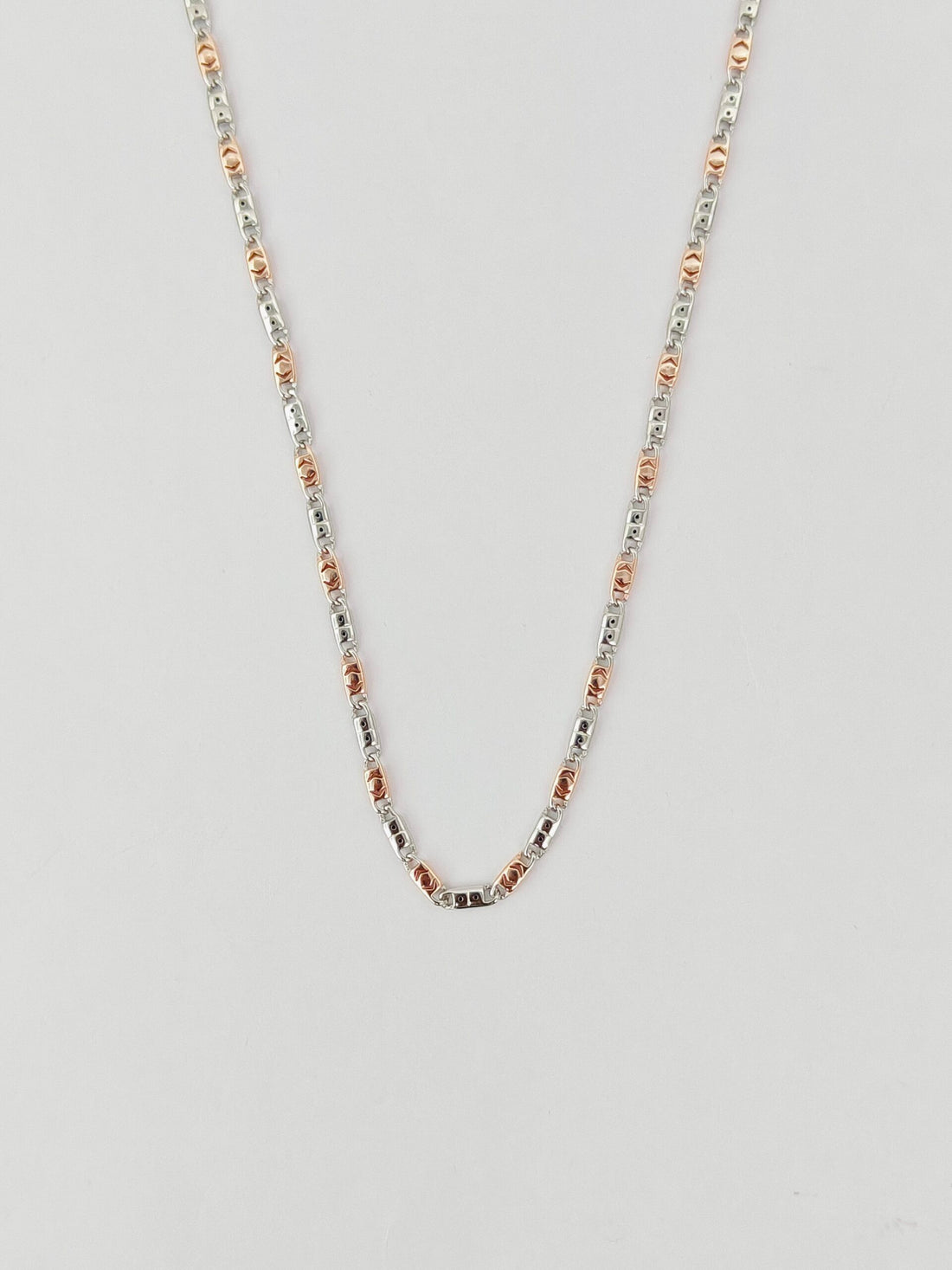 Necklace with small beads on a light gray background
