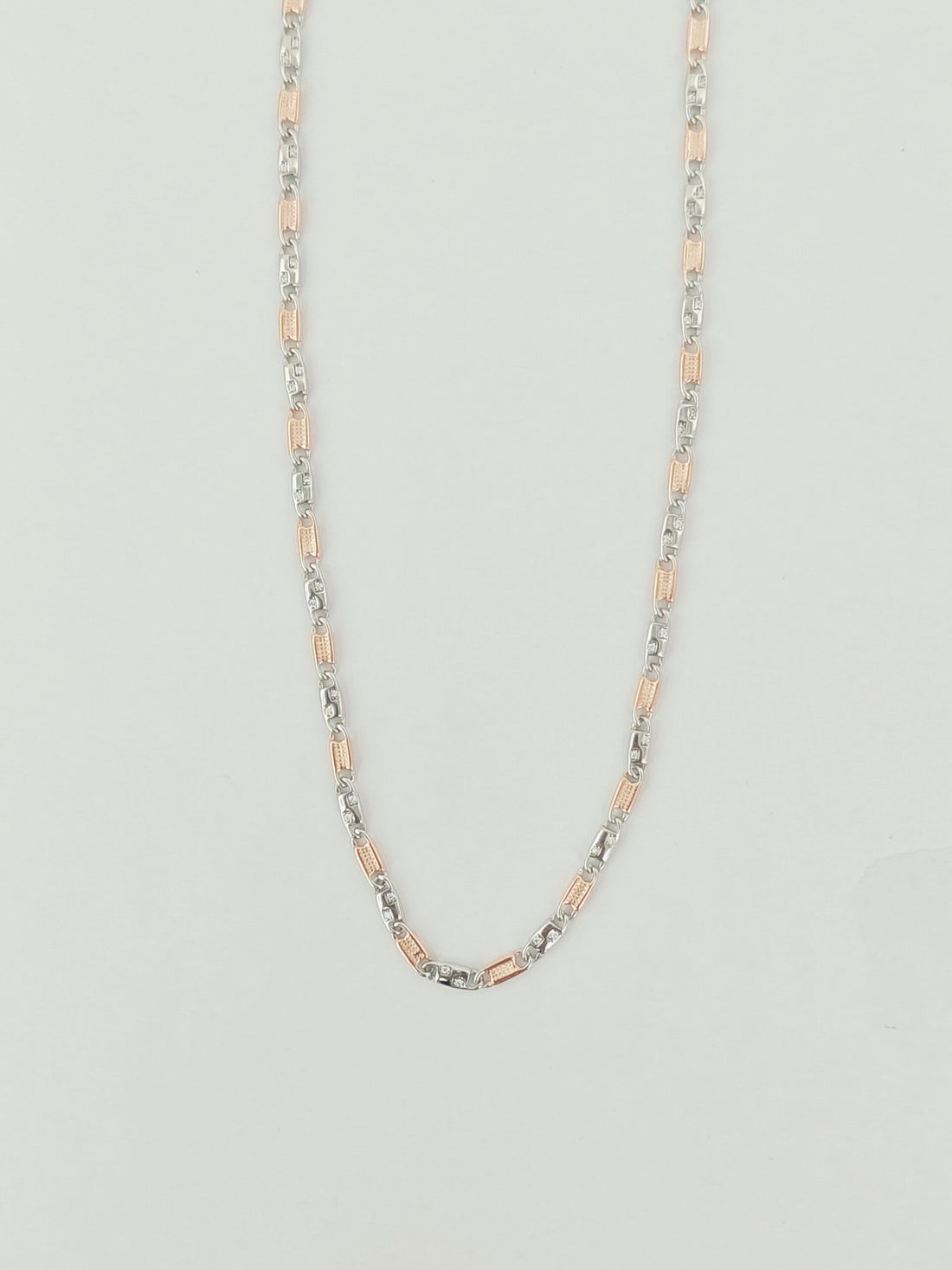 Two-tone chain necklace on a light gray background