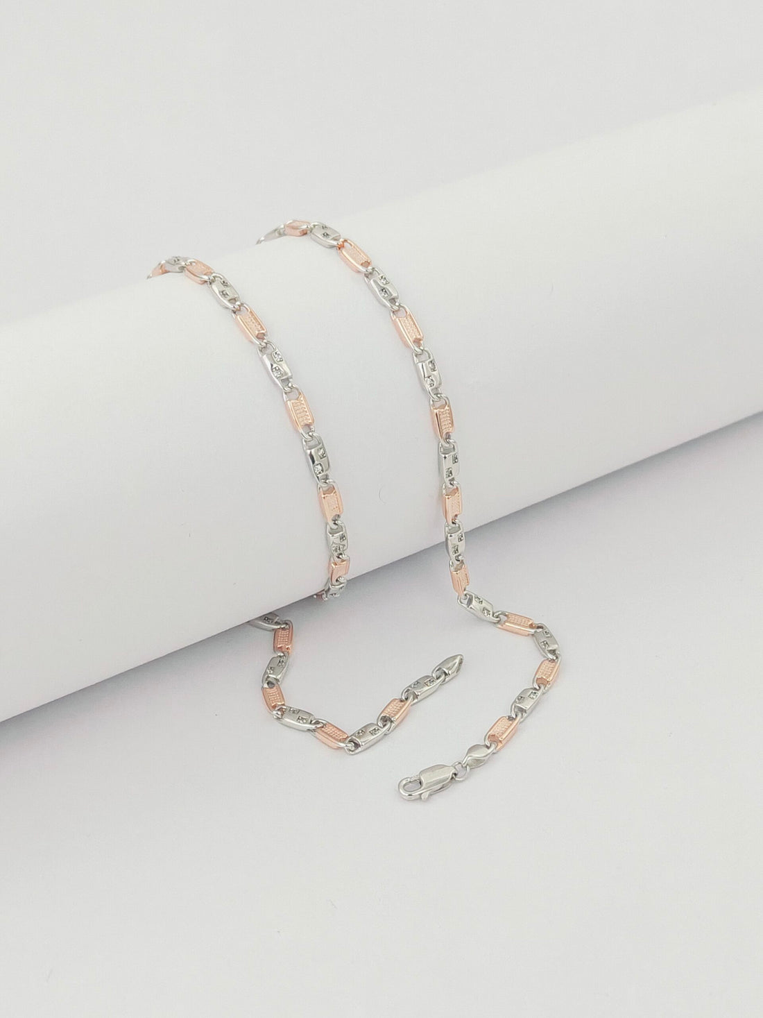 Necklace with pink and silver links on a light gray background