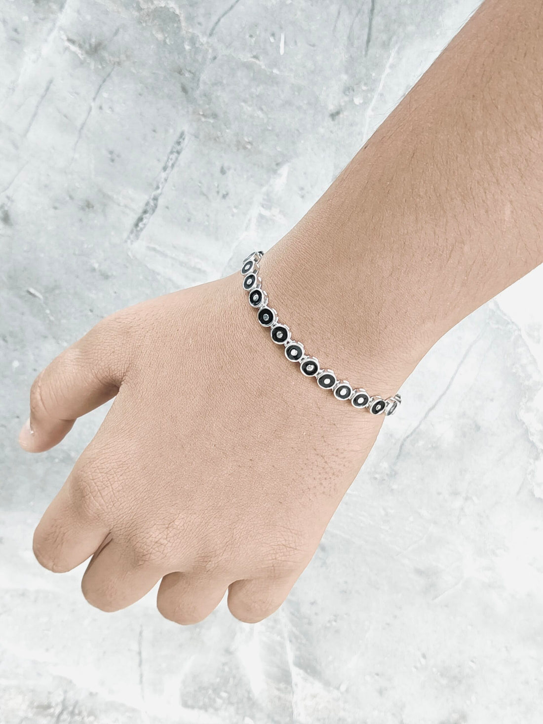 Bracelet on a person's wrist against a light background