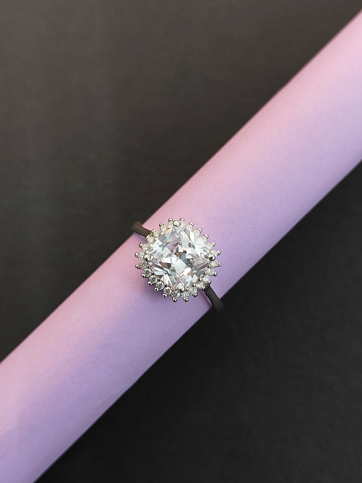 Diamond ring on a pink and black background