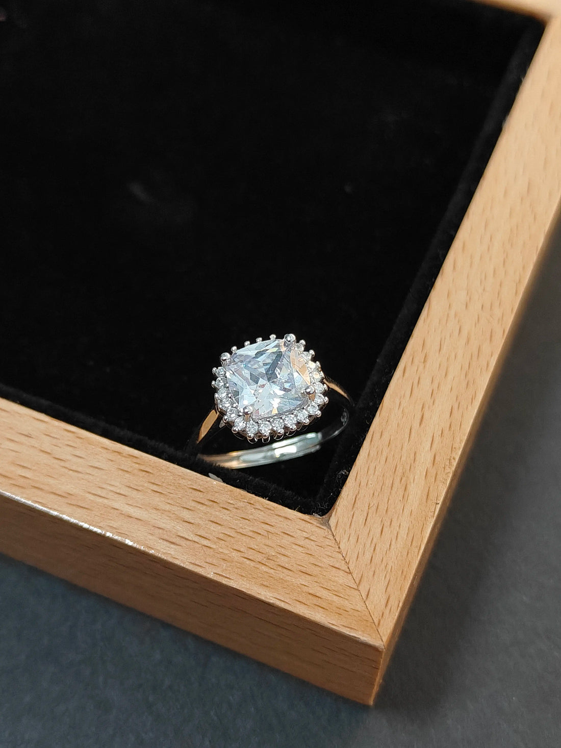 Diamond ring in a wooden box with black interior