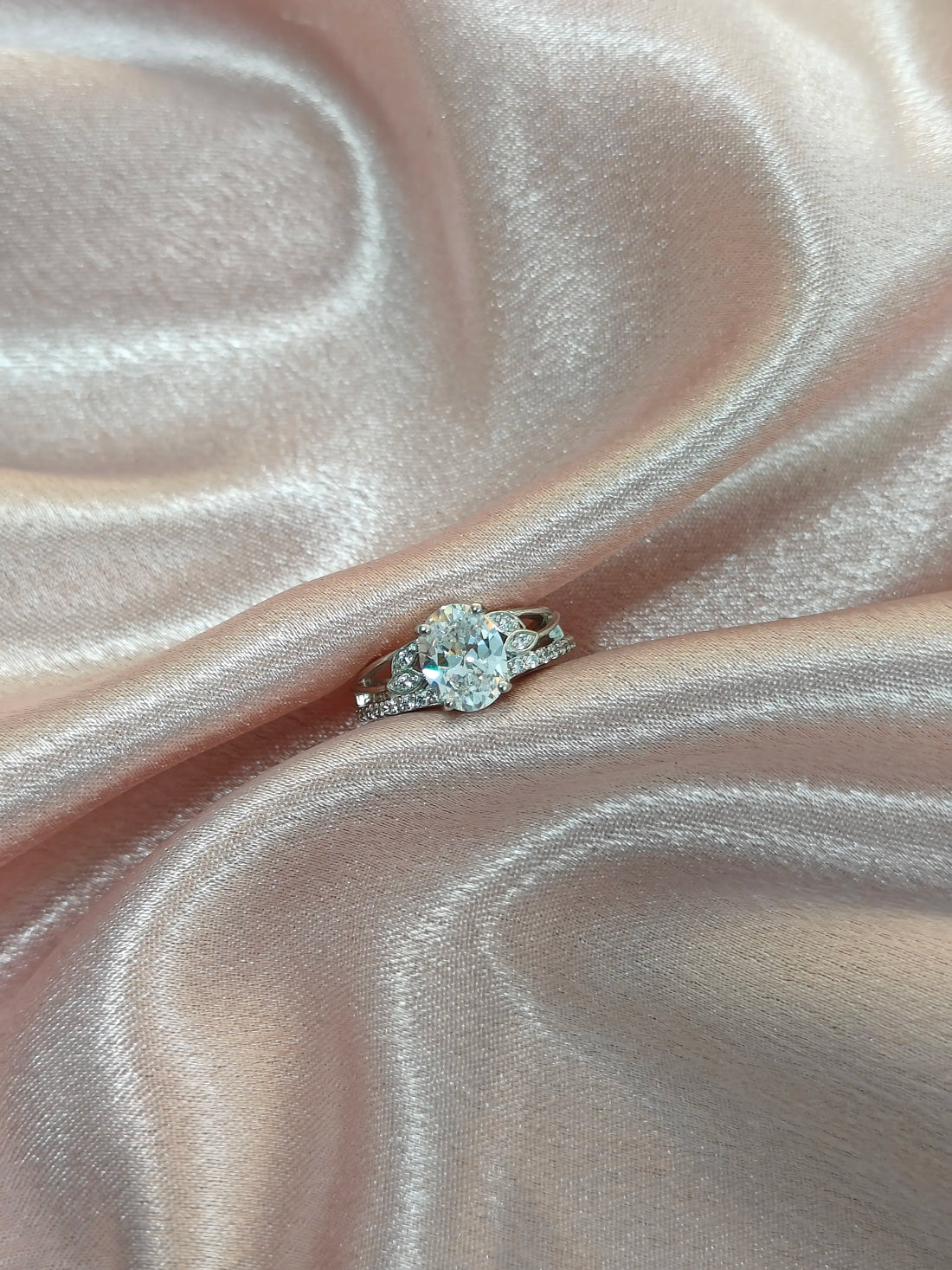 Diamond ring on a pink satin surface