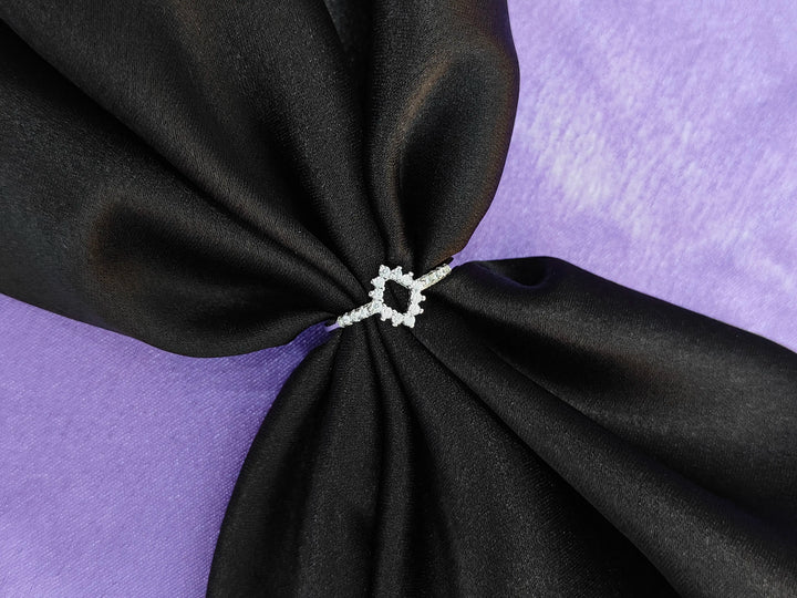 Black fabric with a silver ring on a purple background