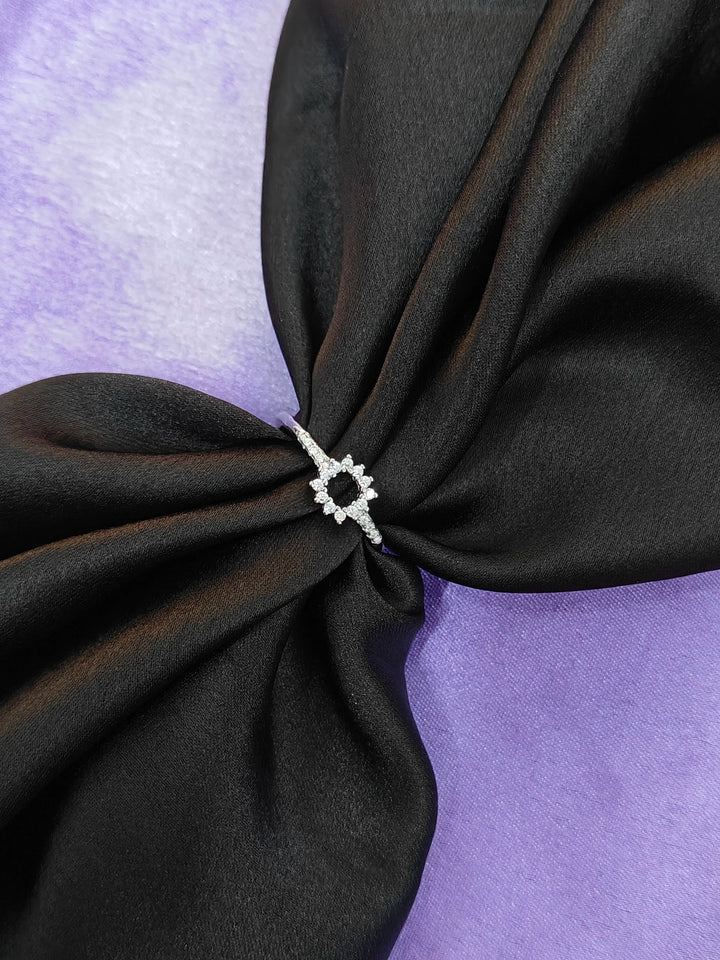 Black fabric with a decorative white knot on a purple background