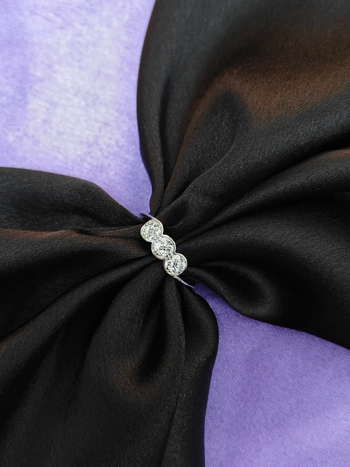 Black fabric with a decorative brooch on a purple background