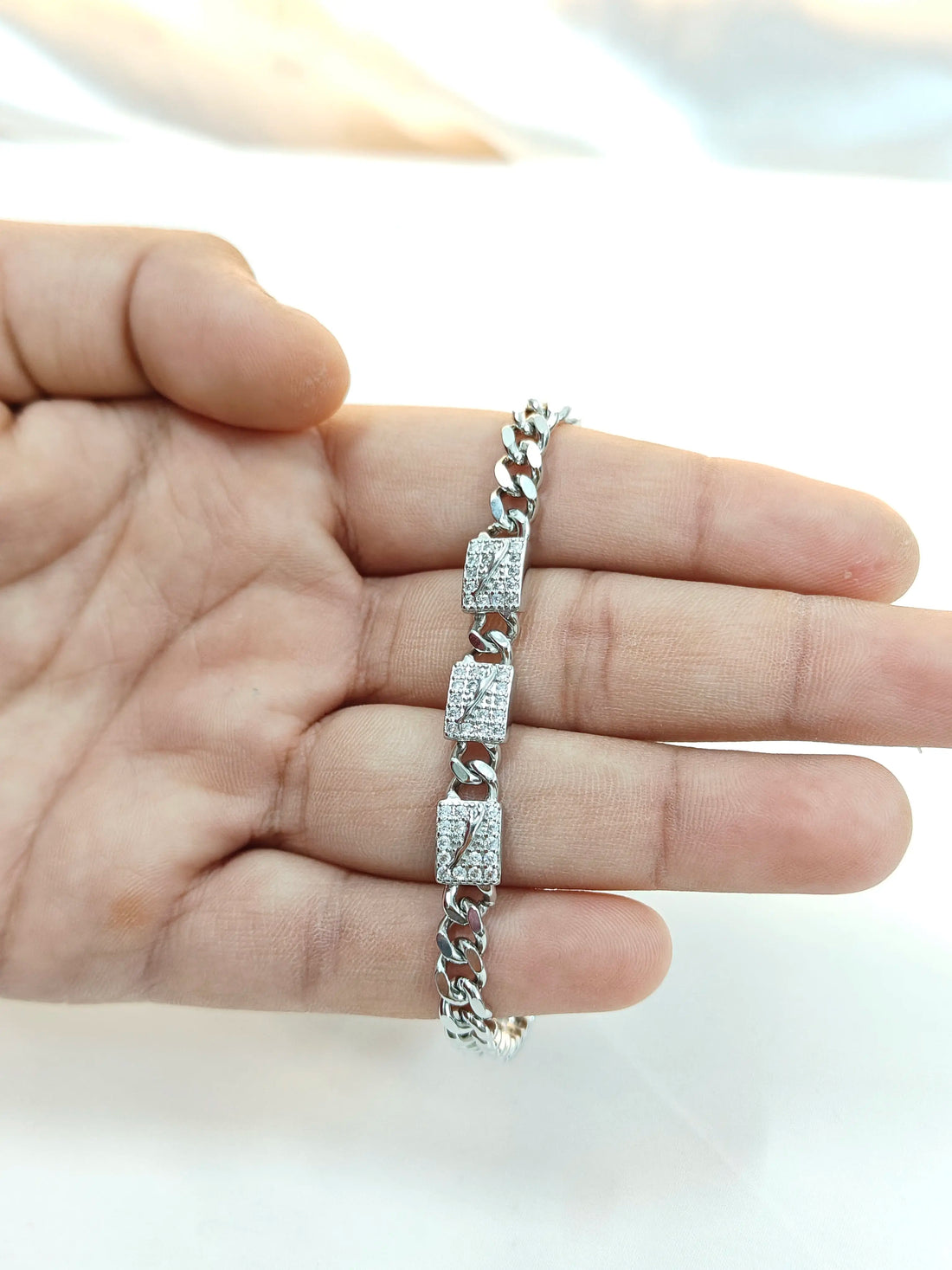 Silver bracelet on a hand with a blurred background