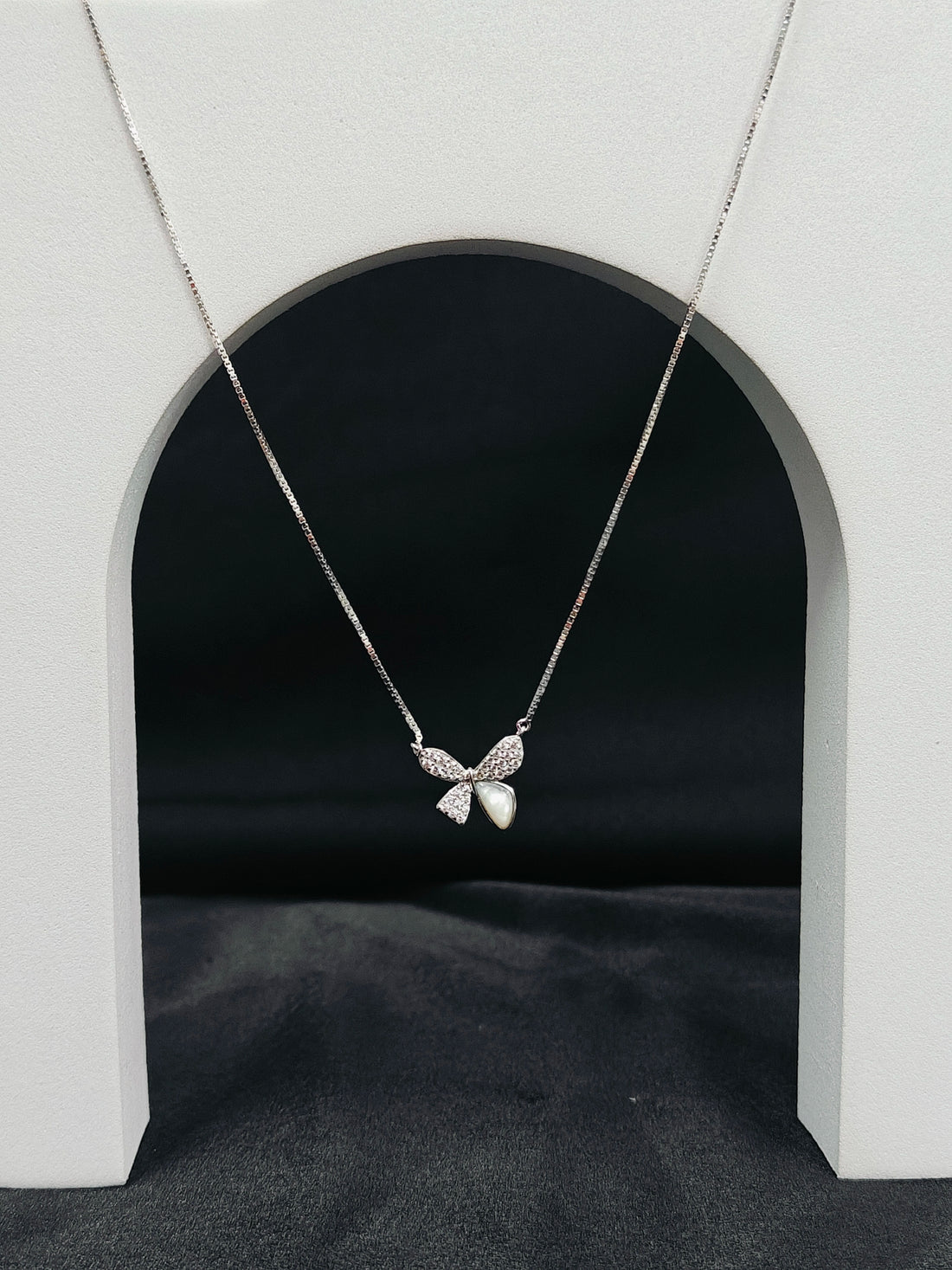 Butterfly necklace on a gray background