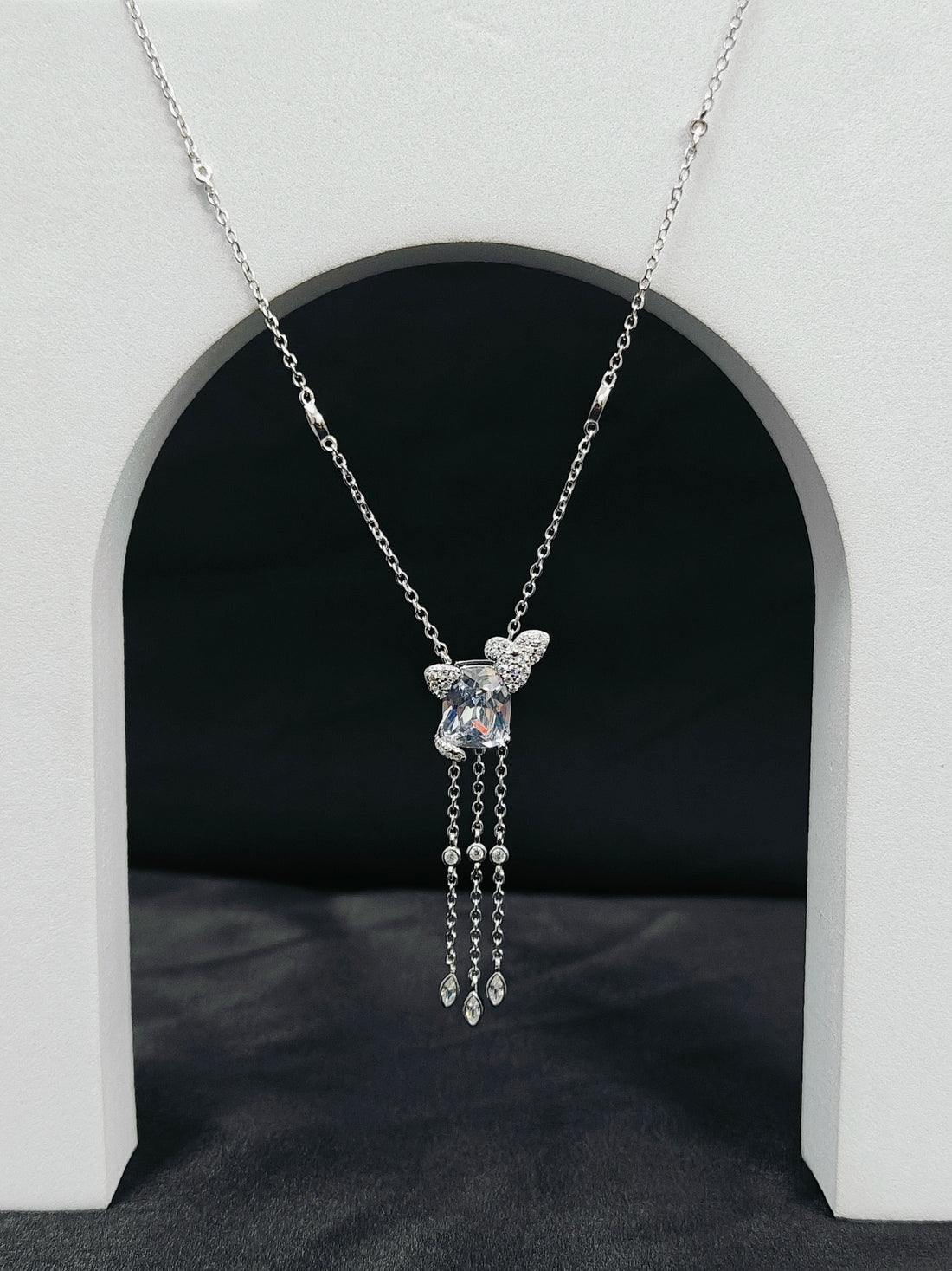 Silver necklace with a pendant on a black background