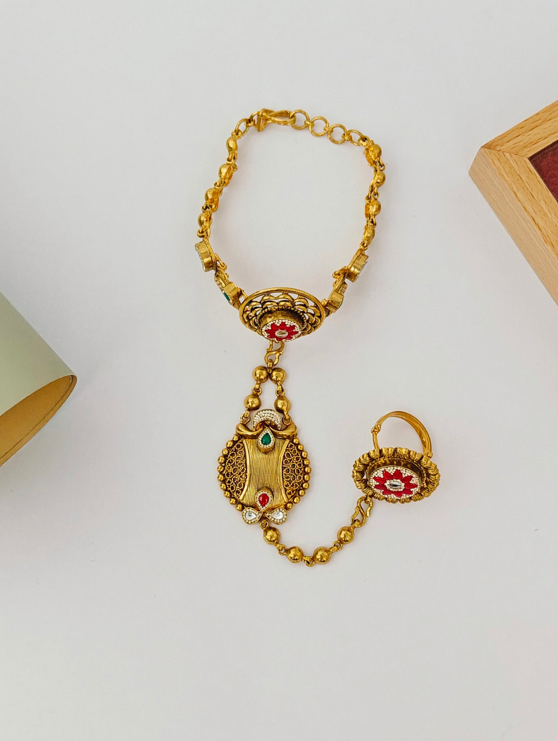 Gold necklace with pendant on a light gray background