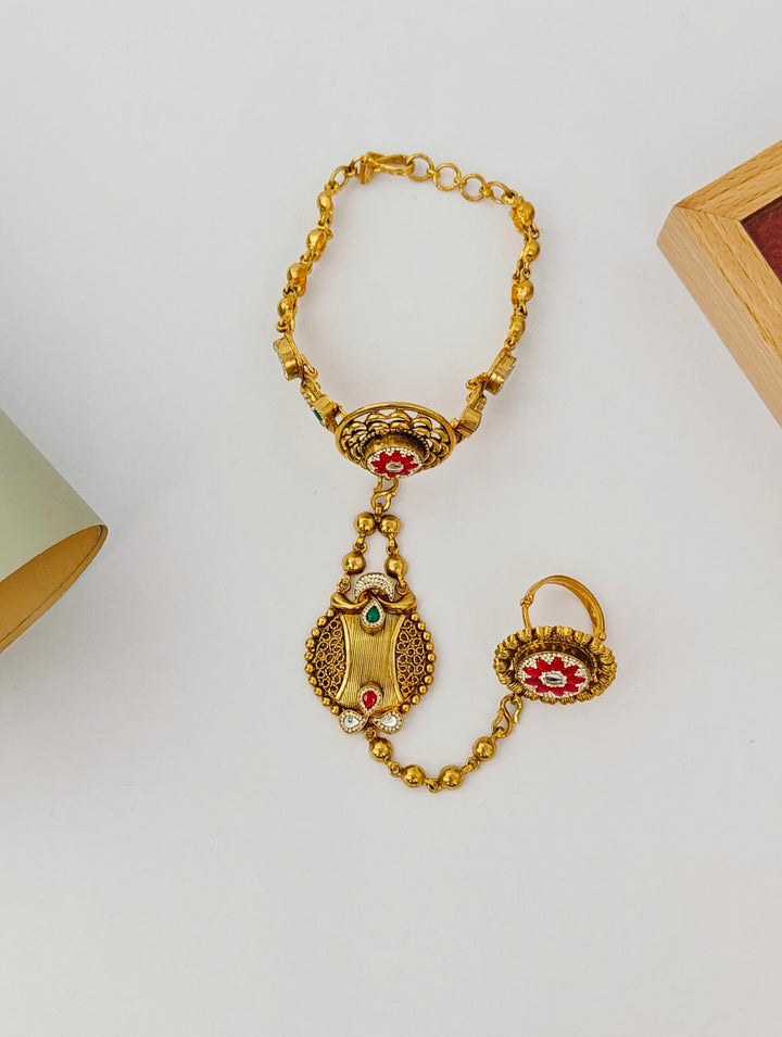 Gold necklace with pendant on a light gray background