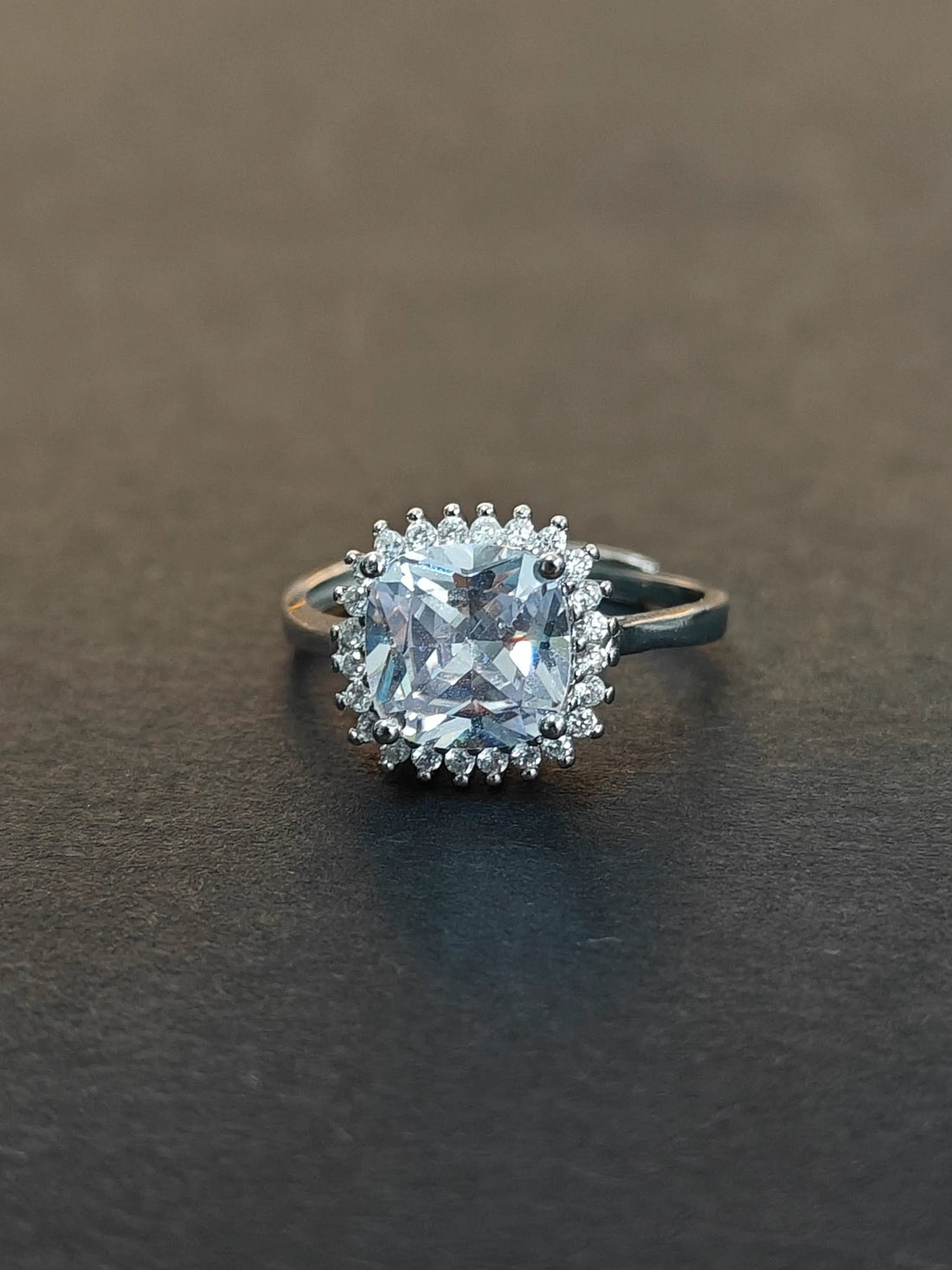 Diamond ring on a dark surface