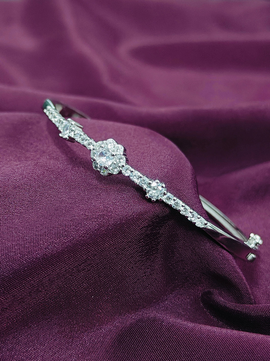 Silver headband with crystals on a purple fabric background