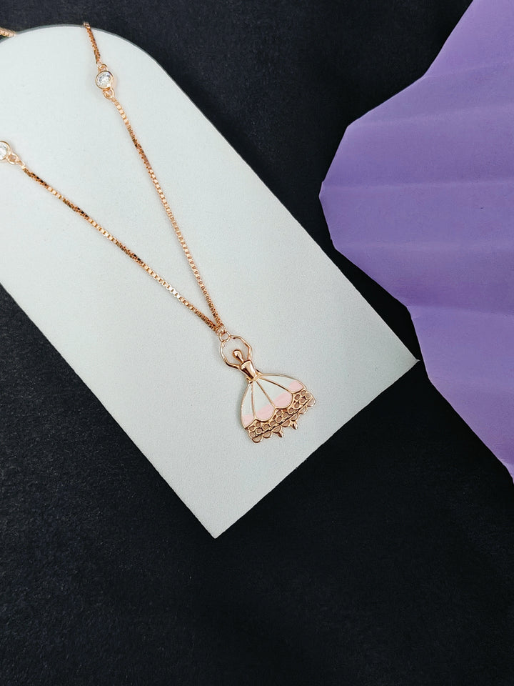 Rose gold necklace with a delicate pendant on a white card against a black background