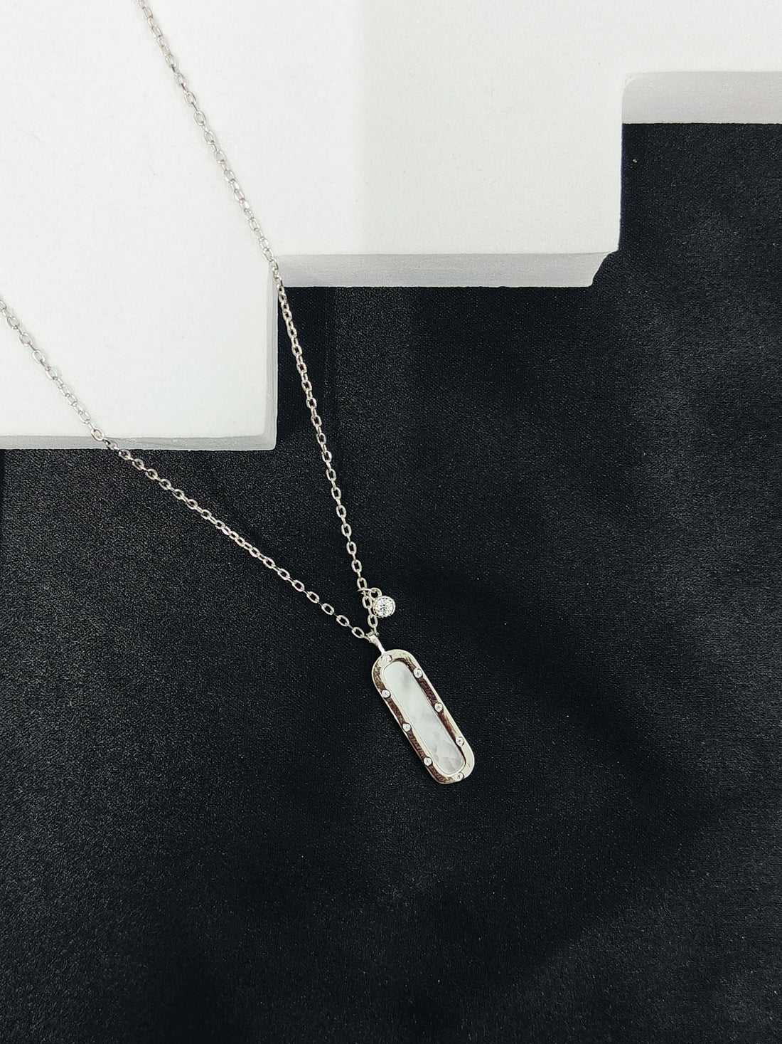 Necklace with a pendant on a black surface