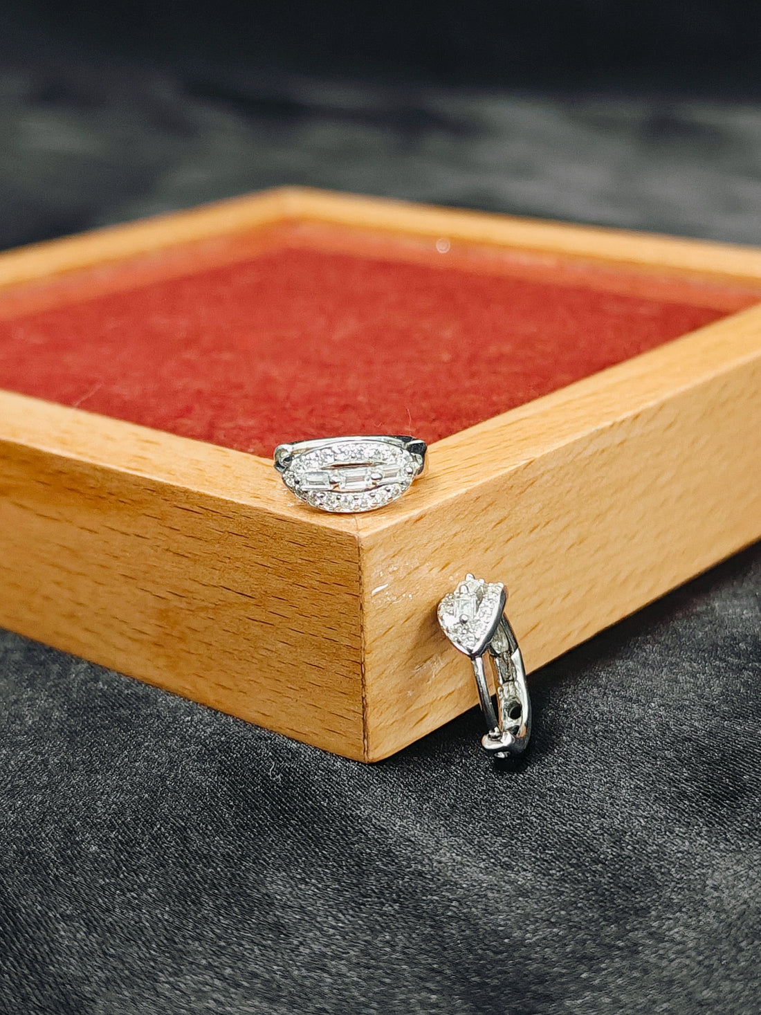 Diamond ring on a wooden box with a dark background