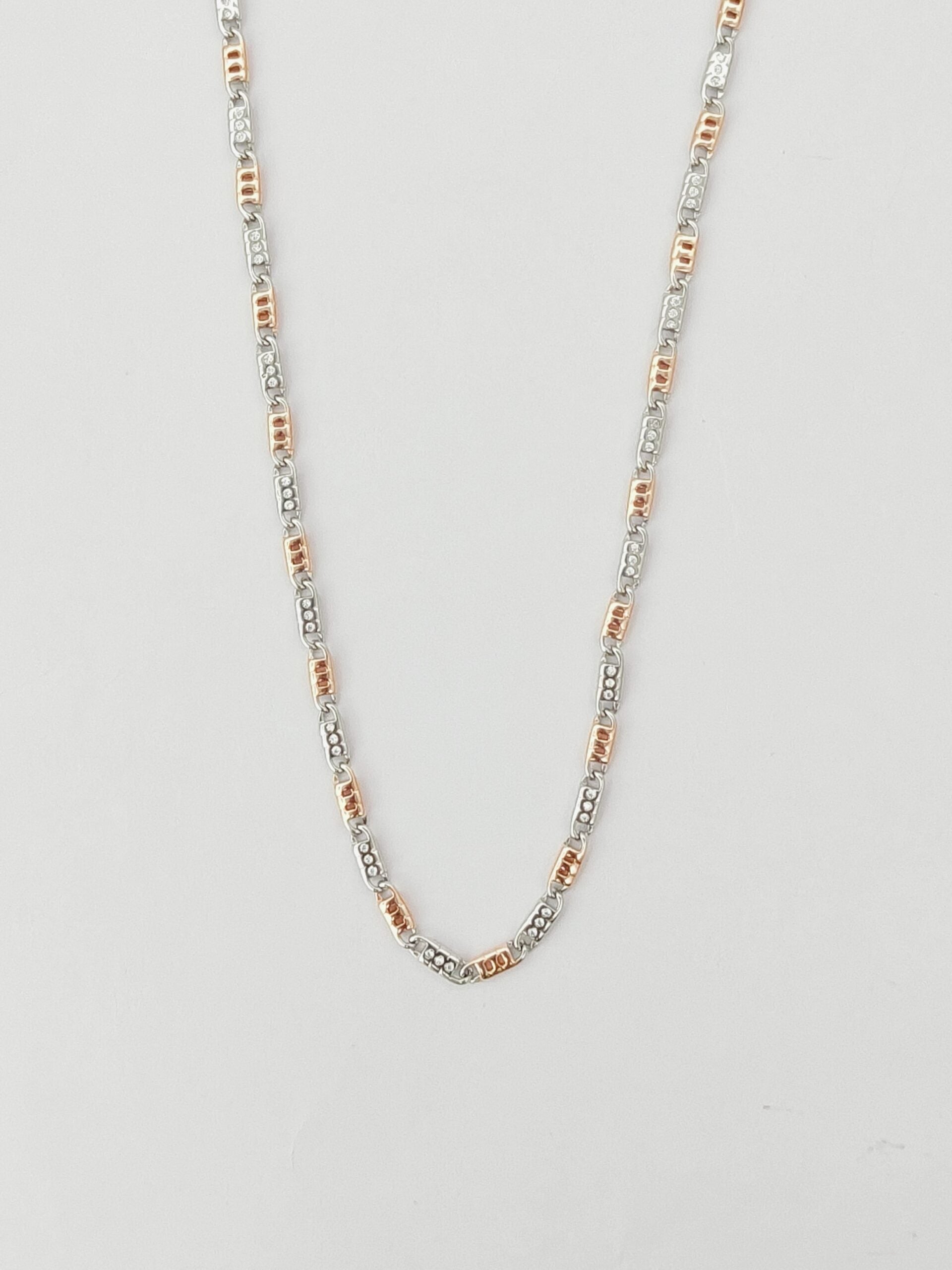 Necklace with small beads on a light gray background