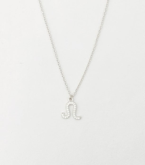Silver necklace with a 'J' pendant on a light gray background