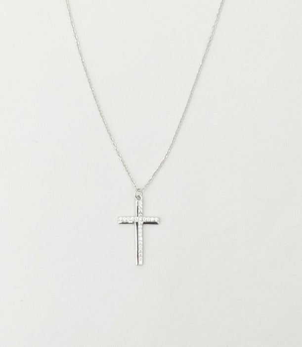 Silver cross necklace on a light gray background