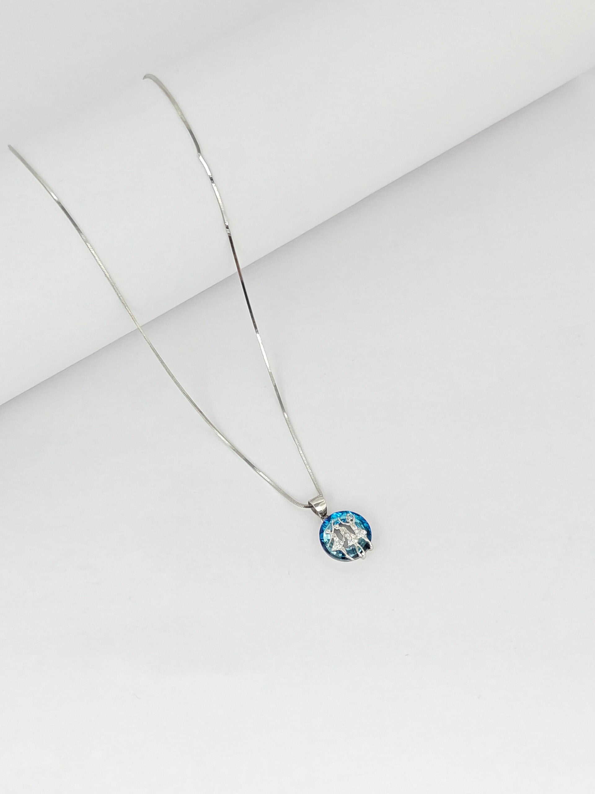 Necklace with a round pendant on a light gray background