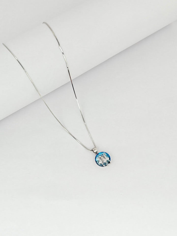 Necklace with a round pendant on a light gray background