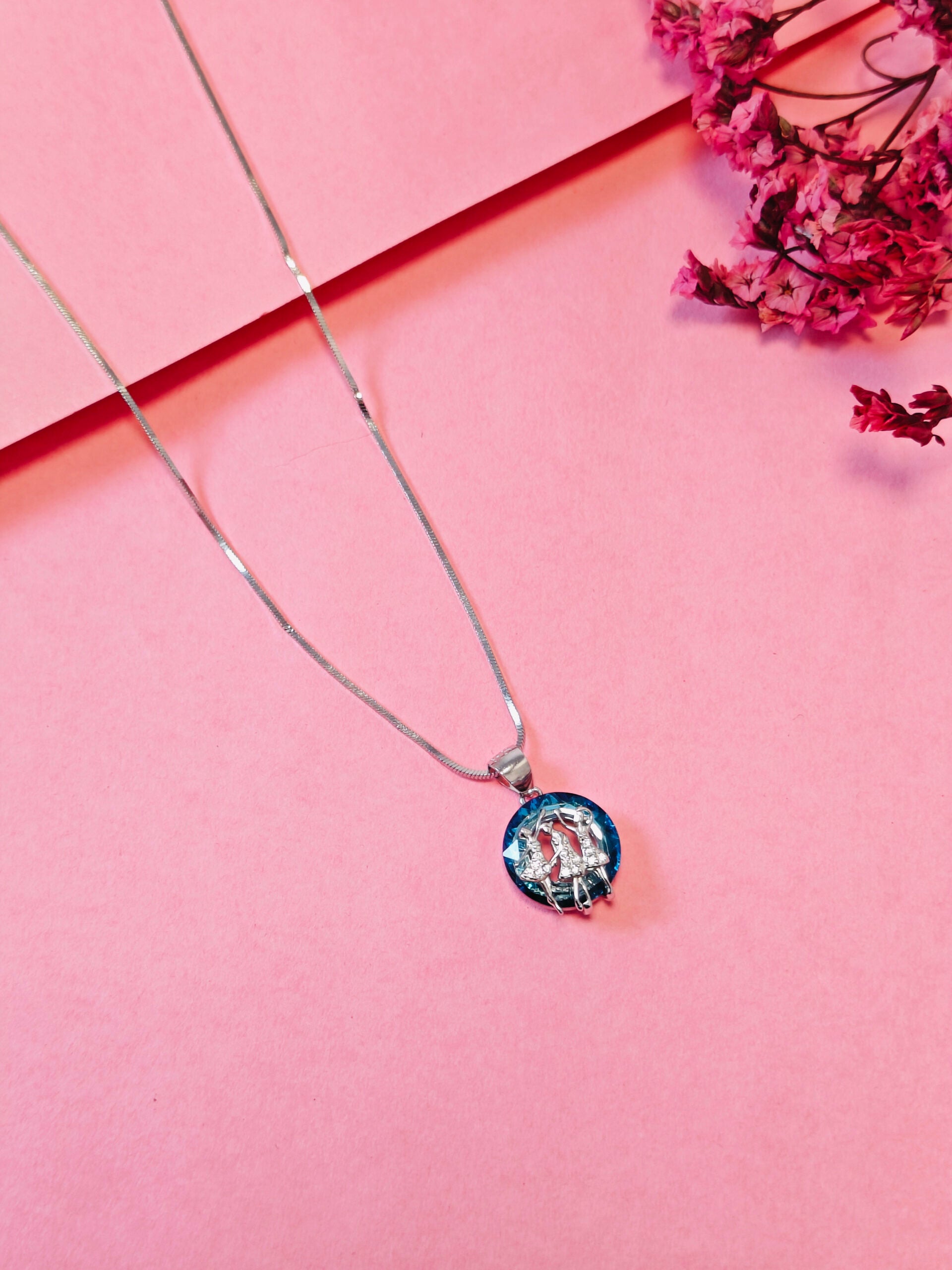 Necklace with a colorful pendant on a pink background