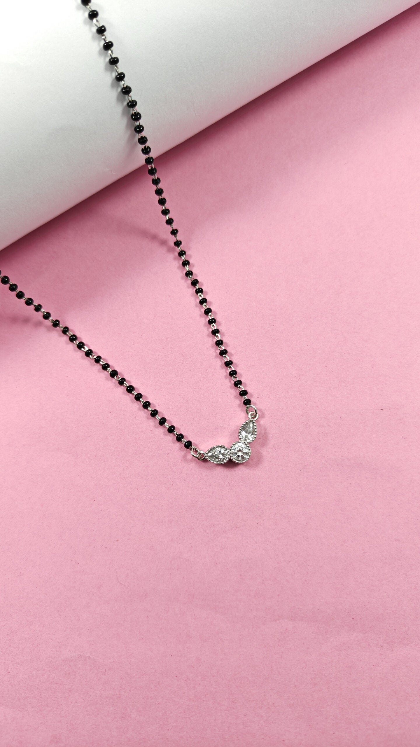 Necklace with a butterfly pendant on a pink background