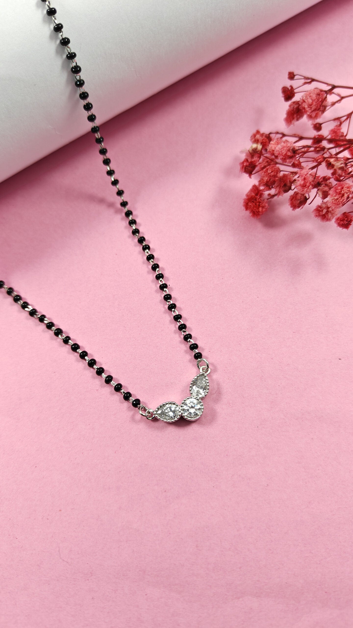 Necklace with a butterfly pendant on a pink background