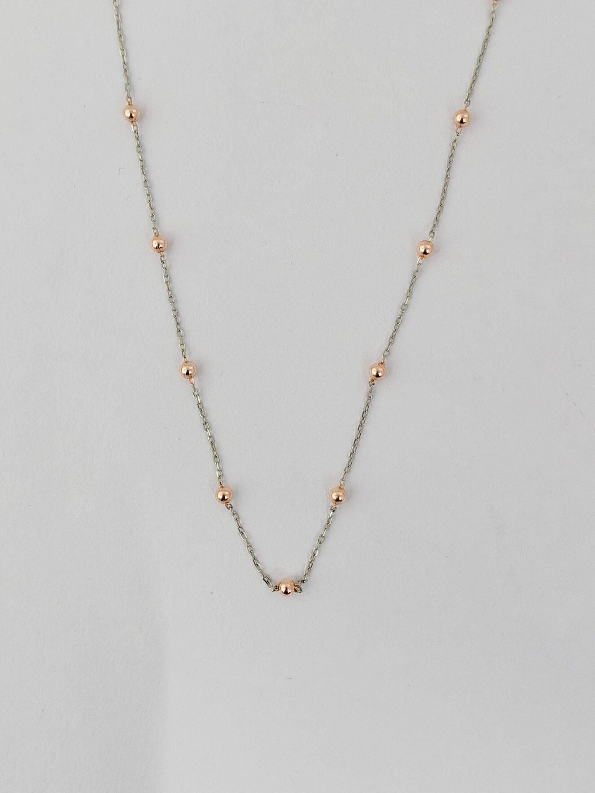 Necklace with small beads on a light gray background