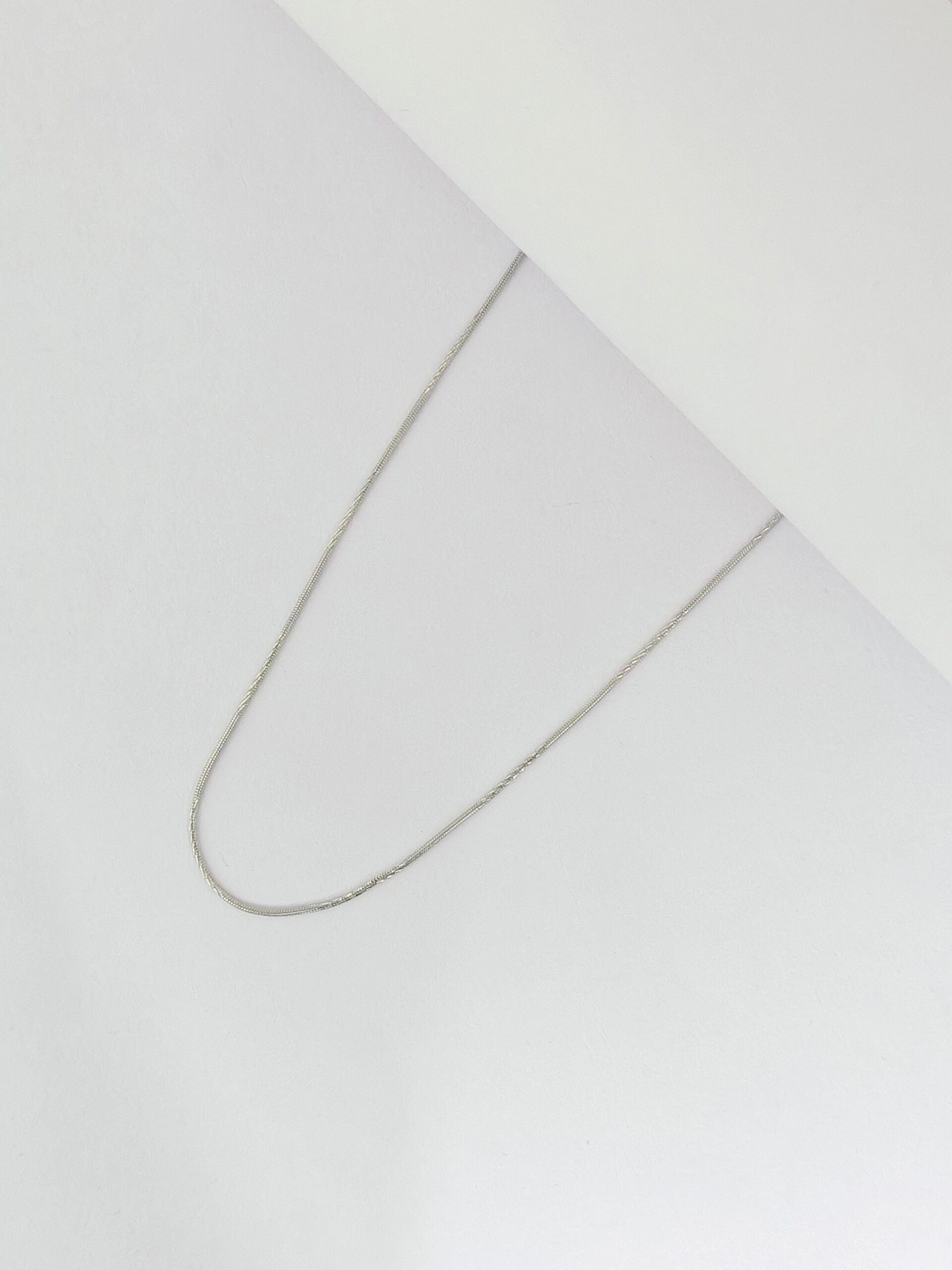 Silver chain on a light gray background