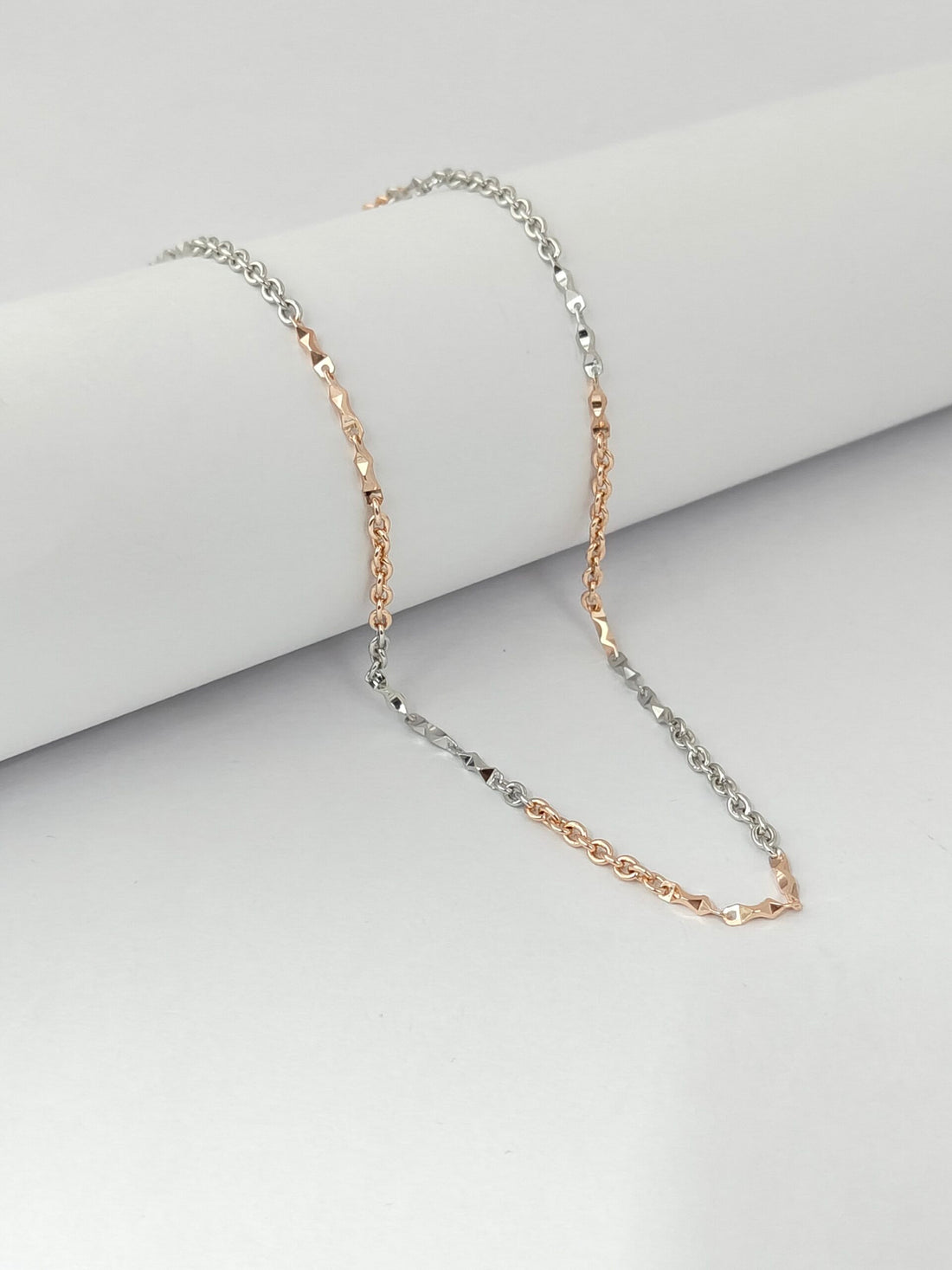 Two-tone necklace on a light gray background
