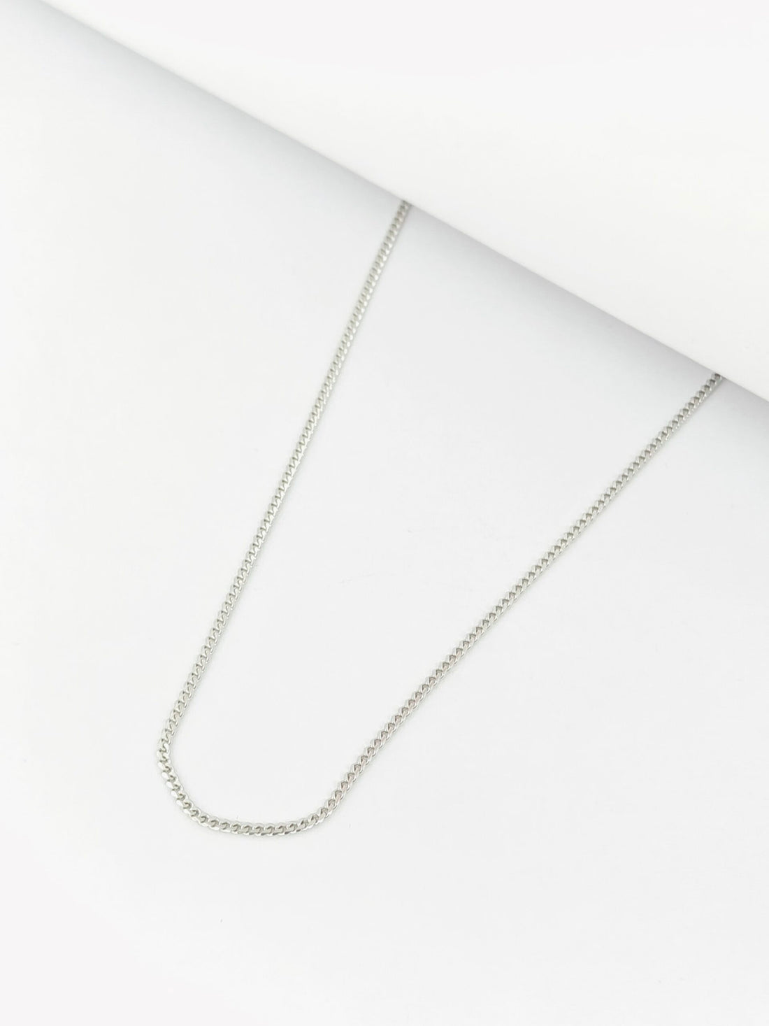 Silver chain necklace on a white background