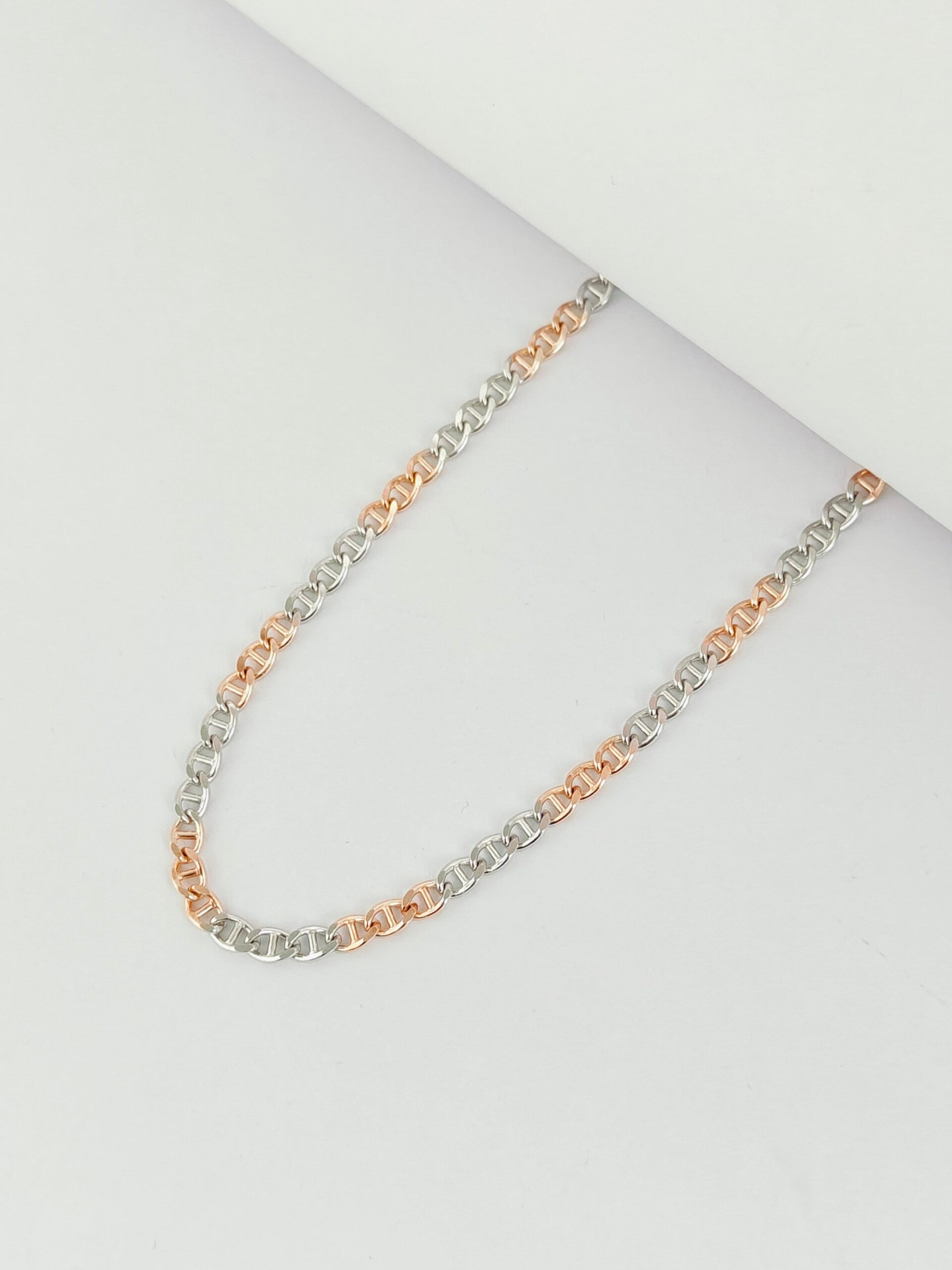 Three-tone necklace on a light gray background