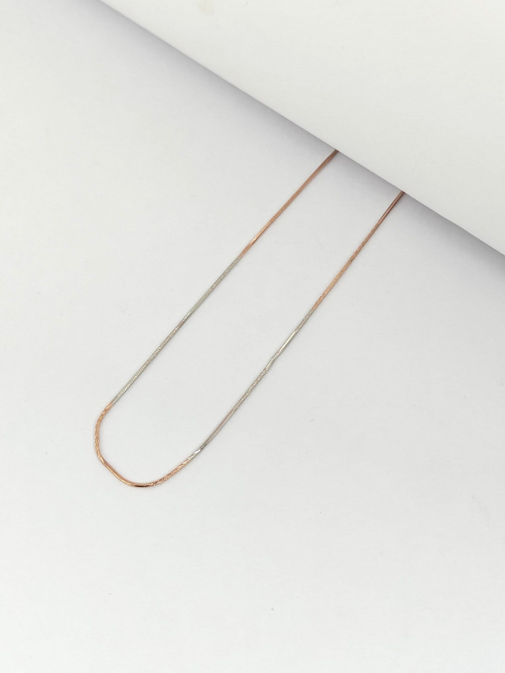 Gold chain necklace on a white background