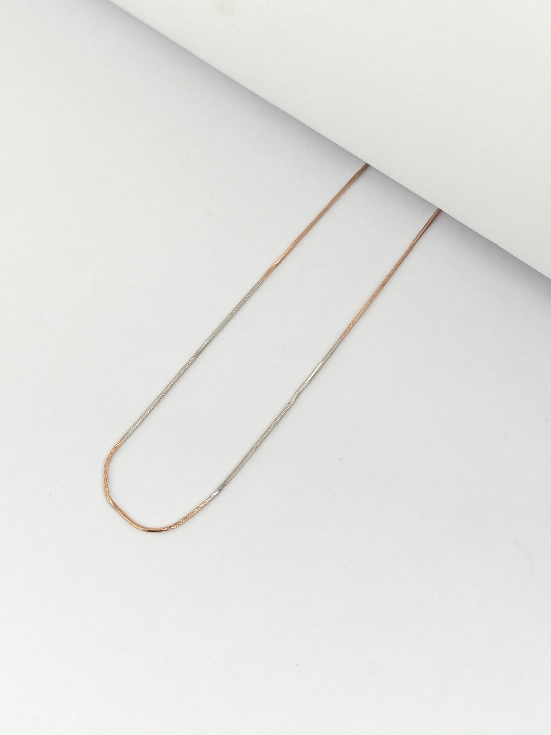 Gold chain necklace on a white background
