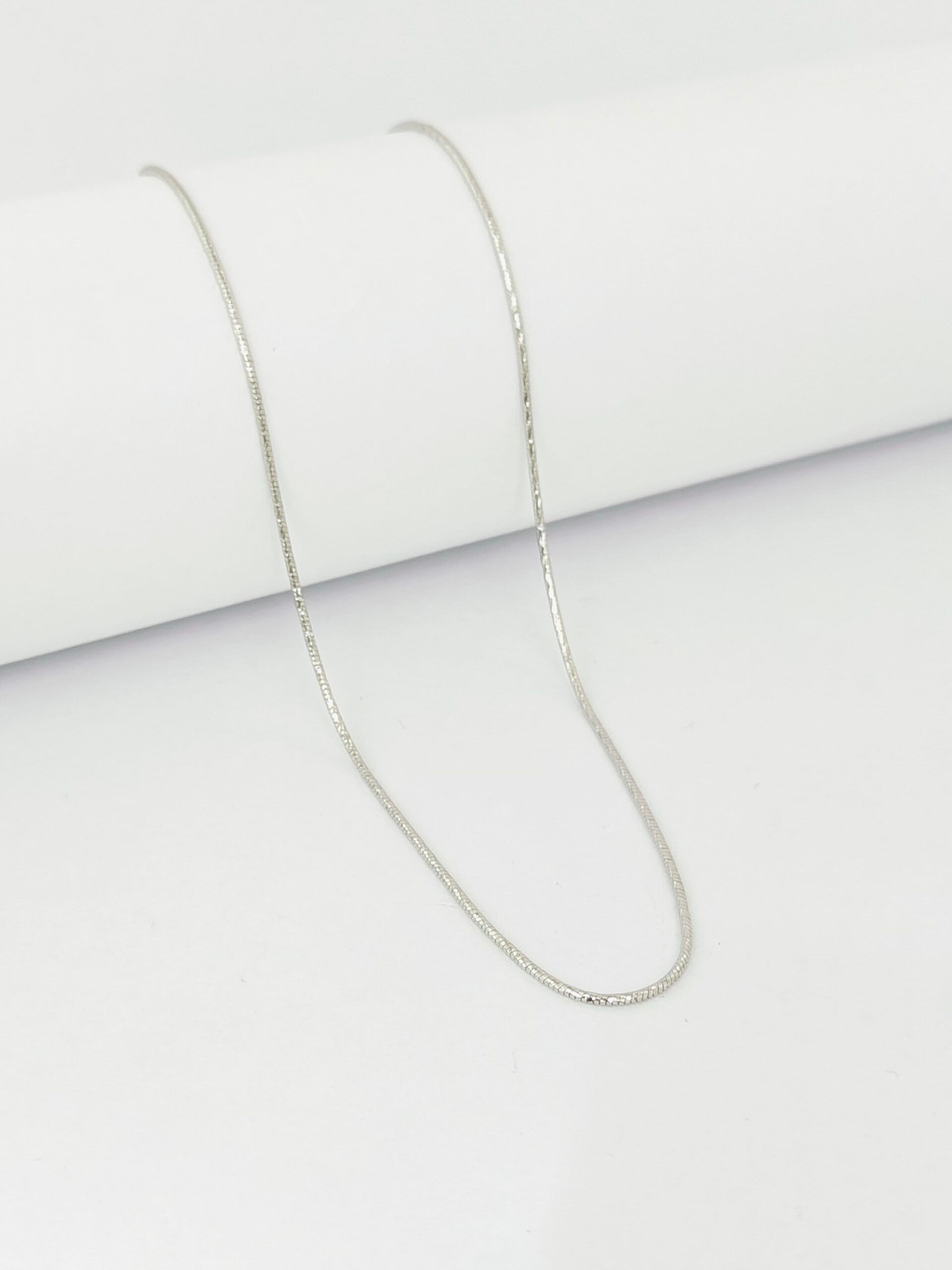 Silver chain necklace on a white background