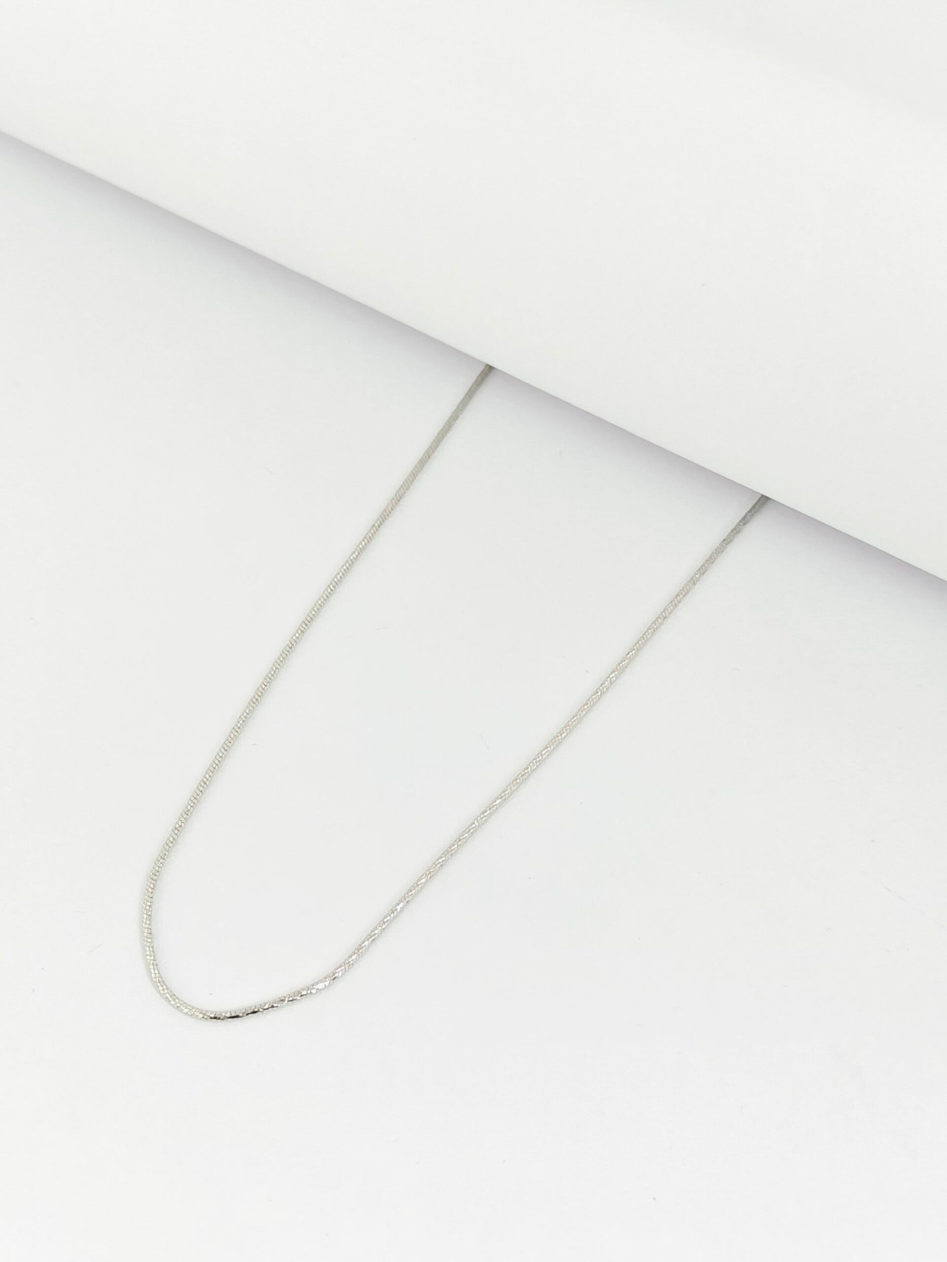 Silver chain necklace on a white background