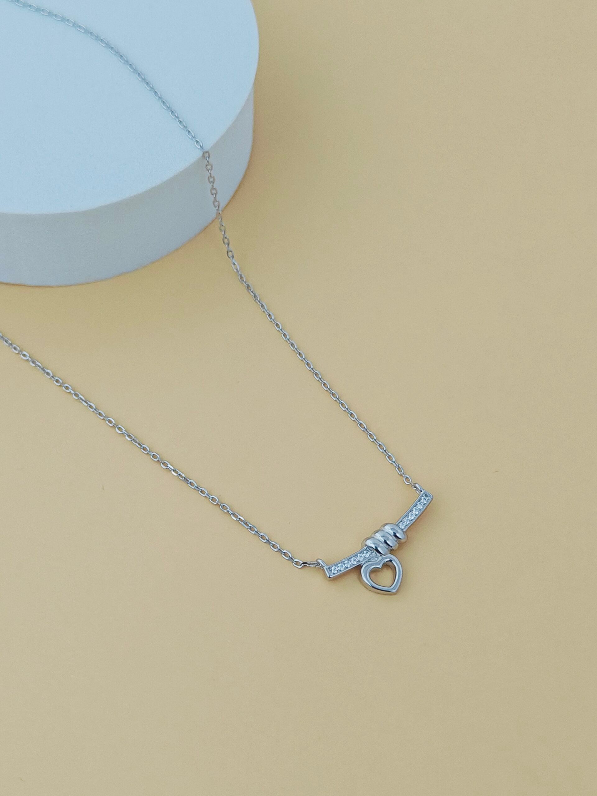Silver necklace on a beige background