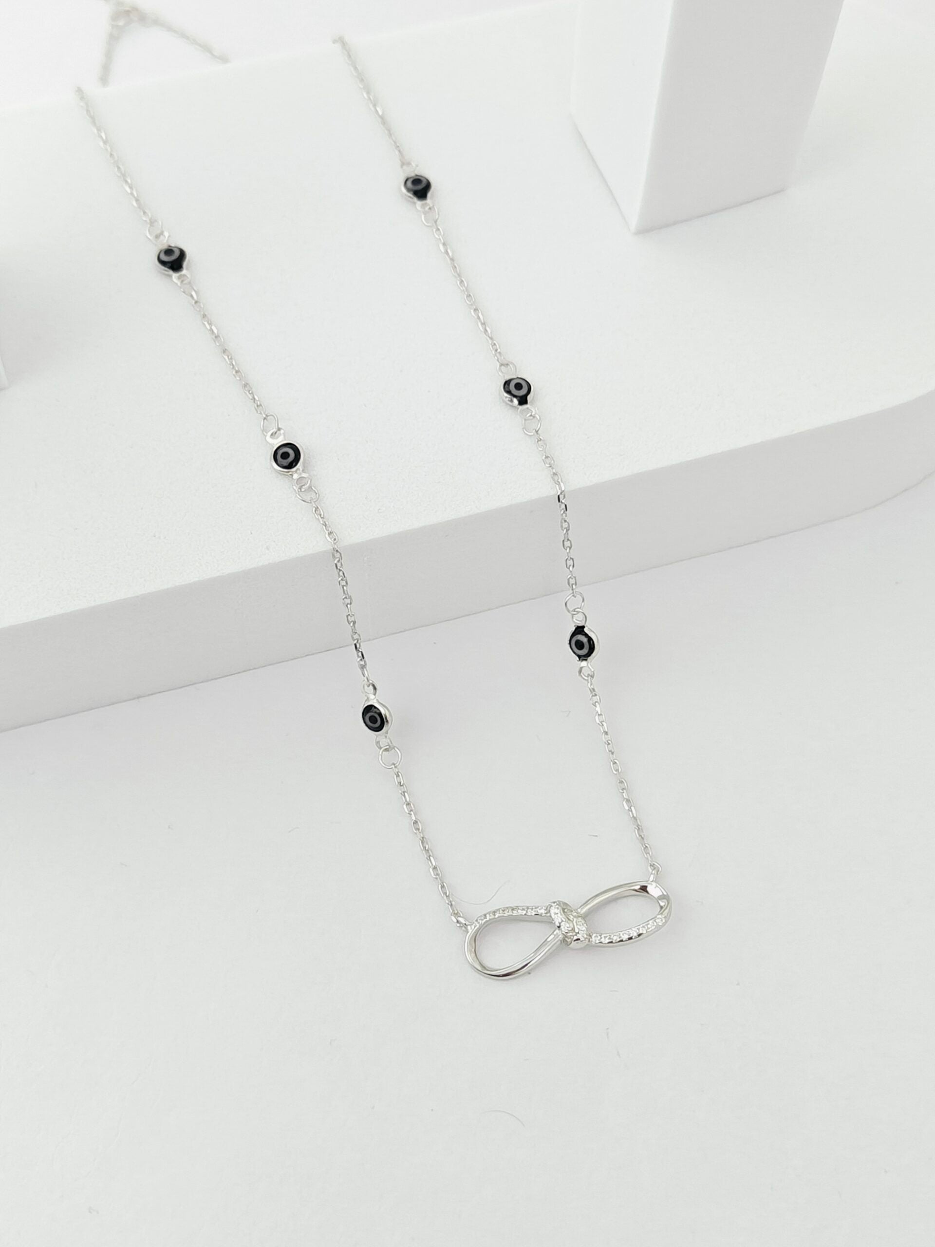 Necklace with black beads and a silver clasp on a white background