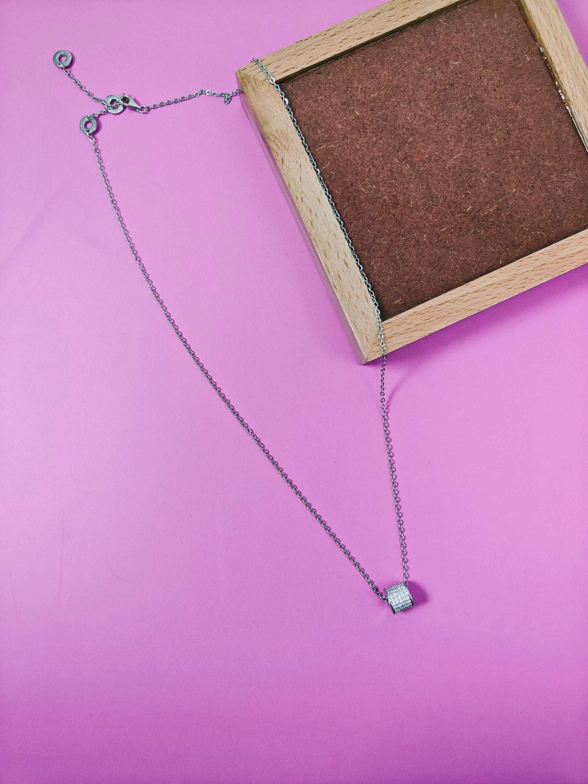 Necklace with a pendant on a pink background