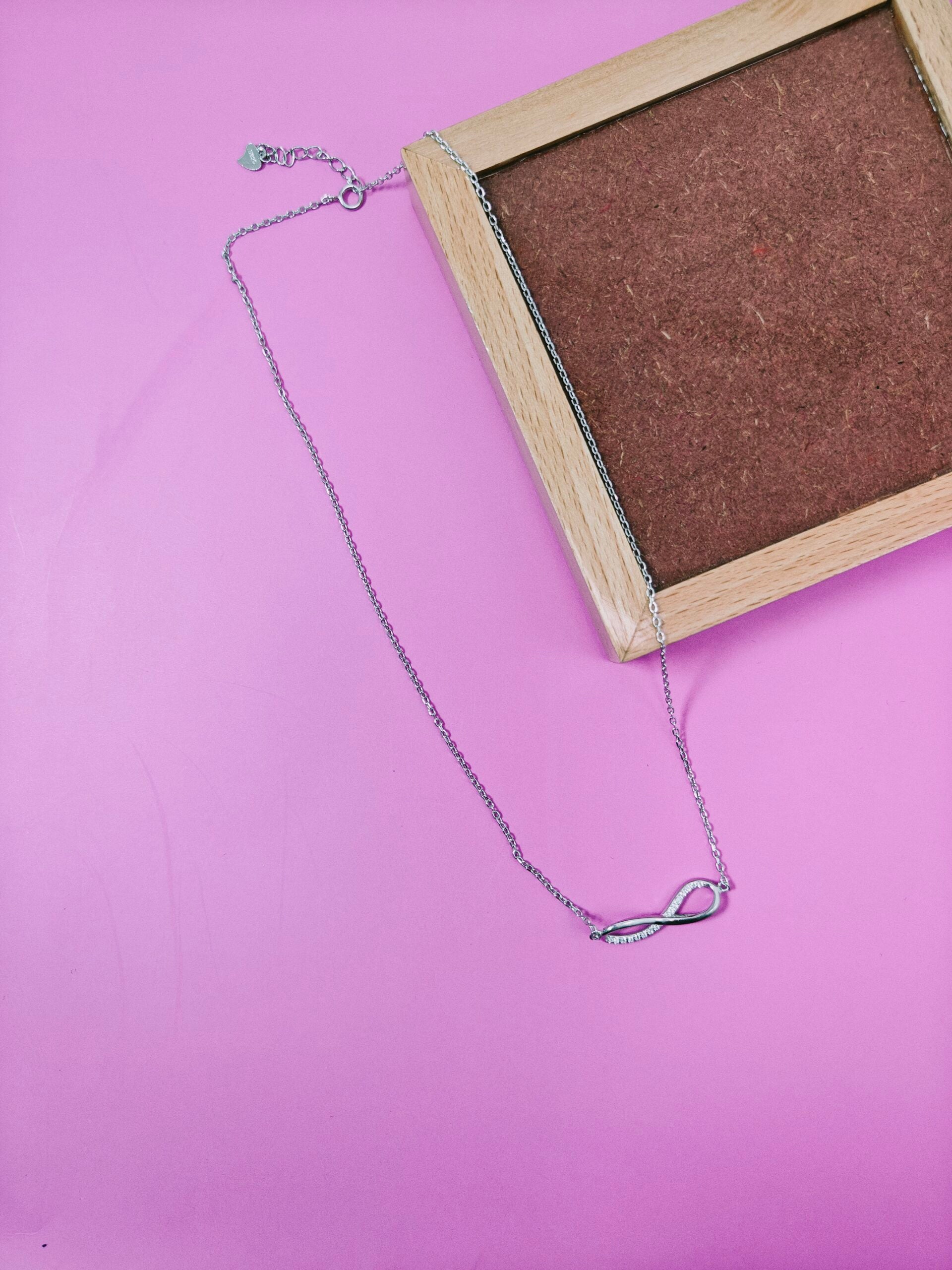 Necklace with a unique pendant on a pink background