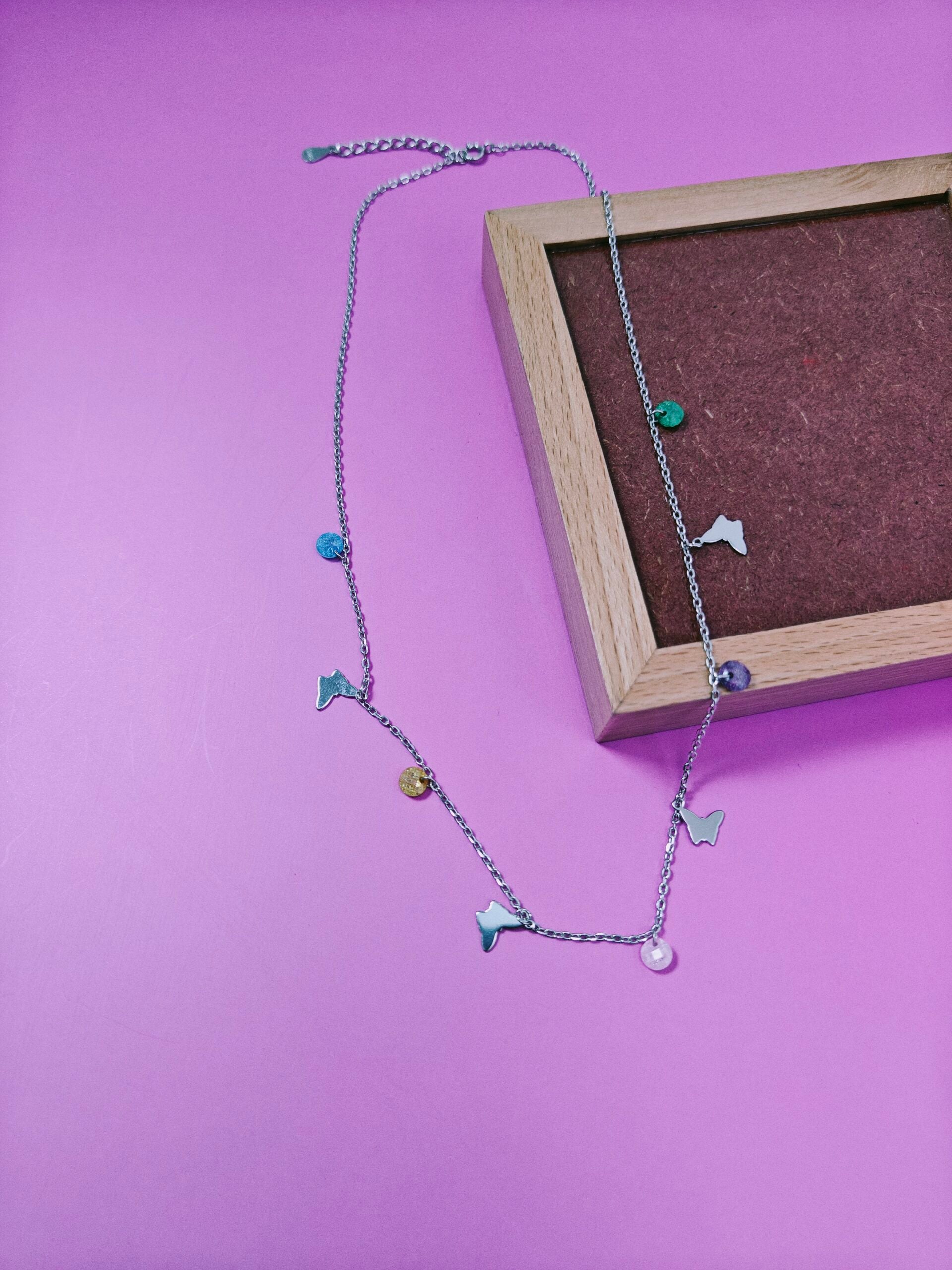 Necklace with star-shaped charms on a purple background