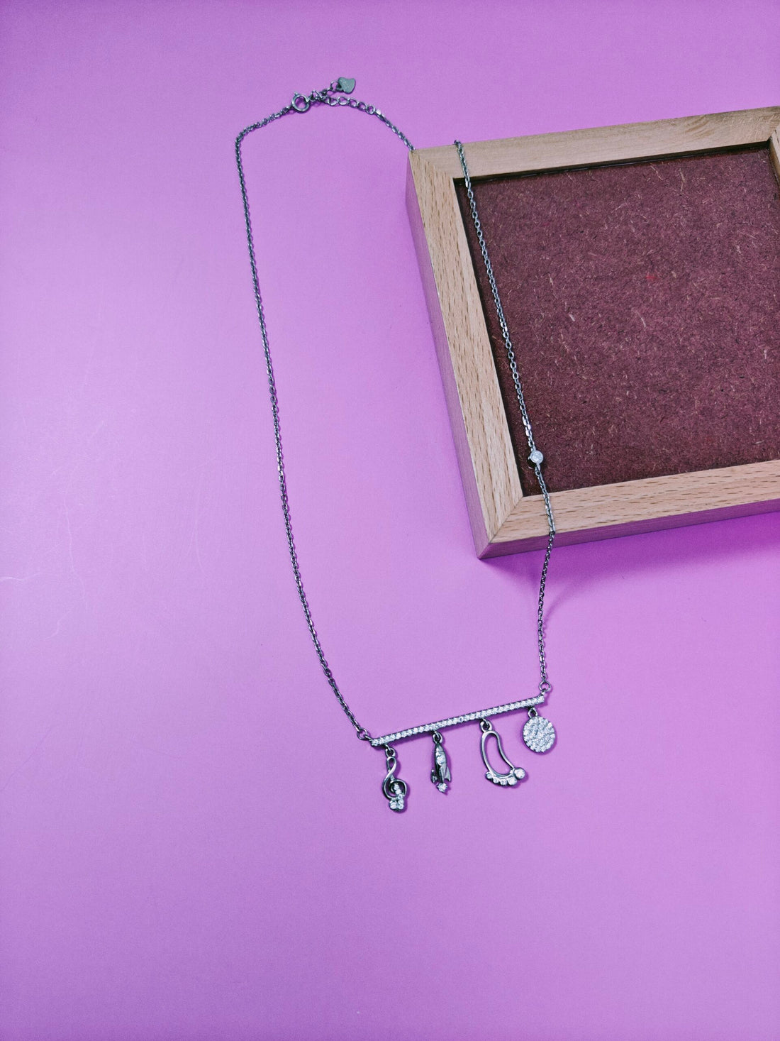 Necklace with charms on a purple background