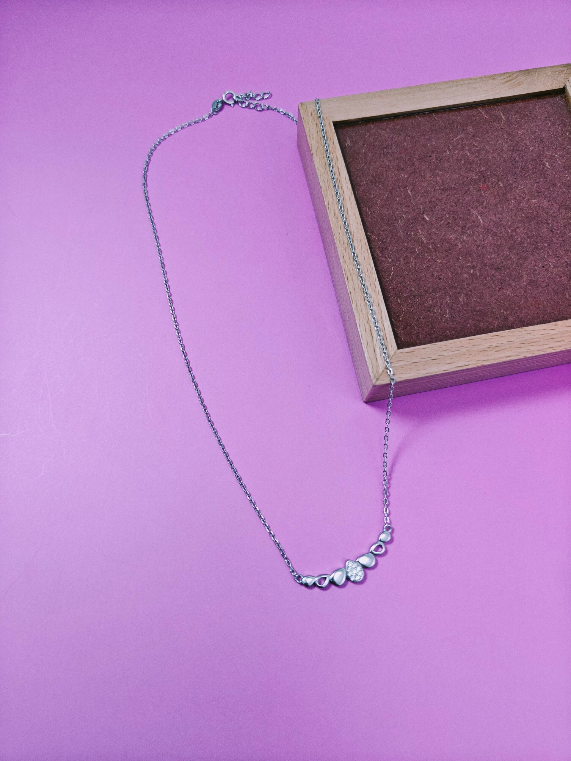 Necklace with heart-shaped pendants on a purple background