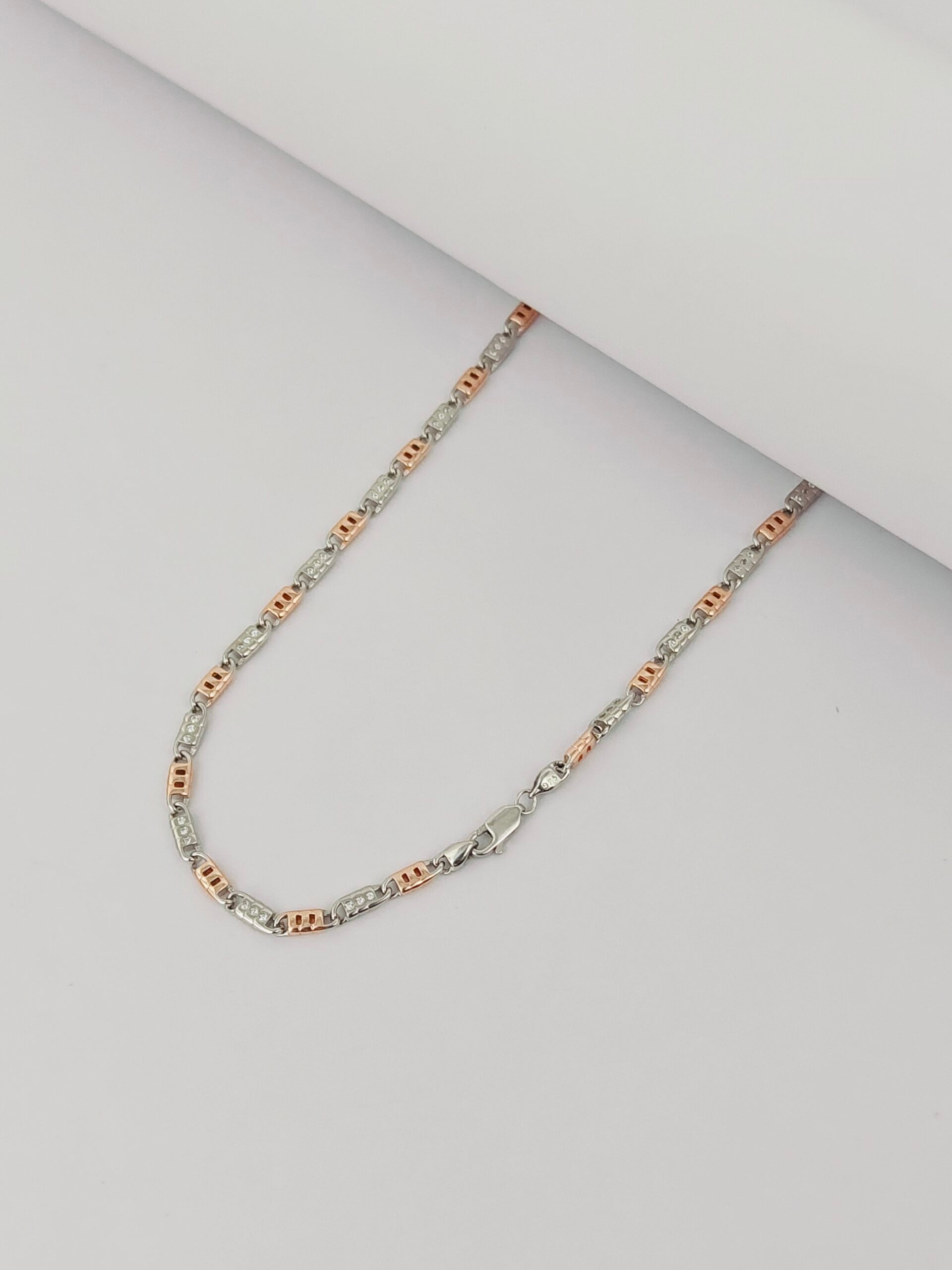 Two-tone necklace on a light gray background