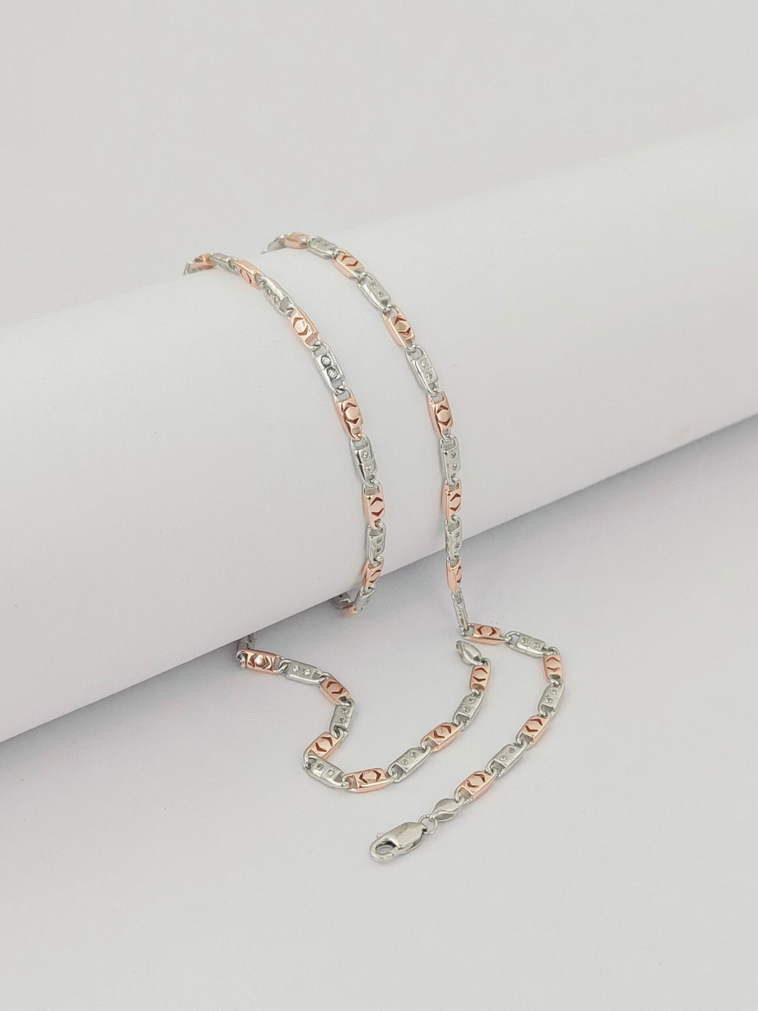 Two-tone chain necklace on a light gray background