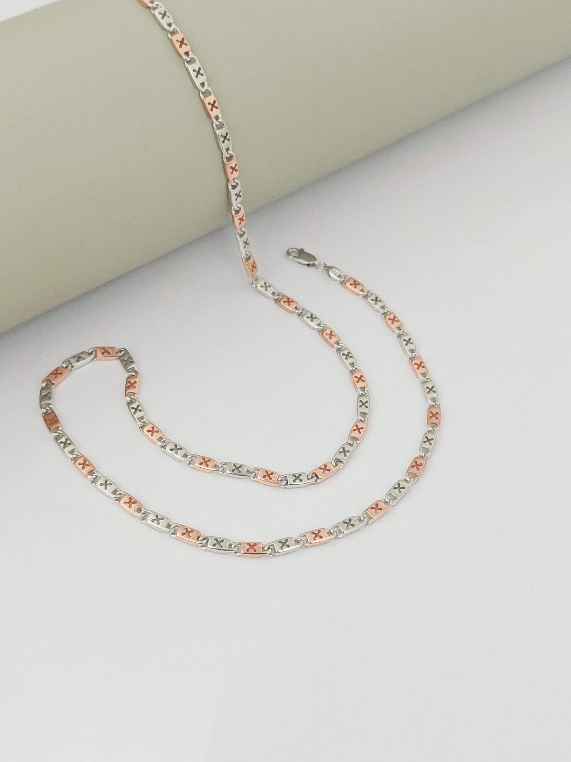 Multicolored chain necklace on a light gray surface